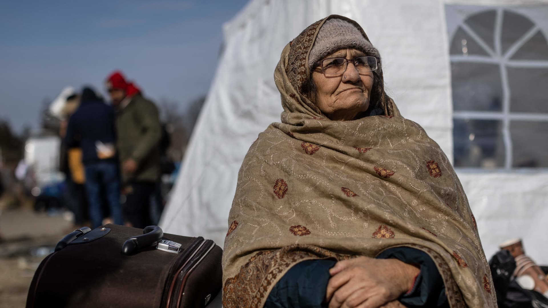 An elderly woman from Pakistan sits at the border crossing in Medyka, eastern Poland as refugees continue to arrive from Ukraine on March 1, 2022.