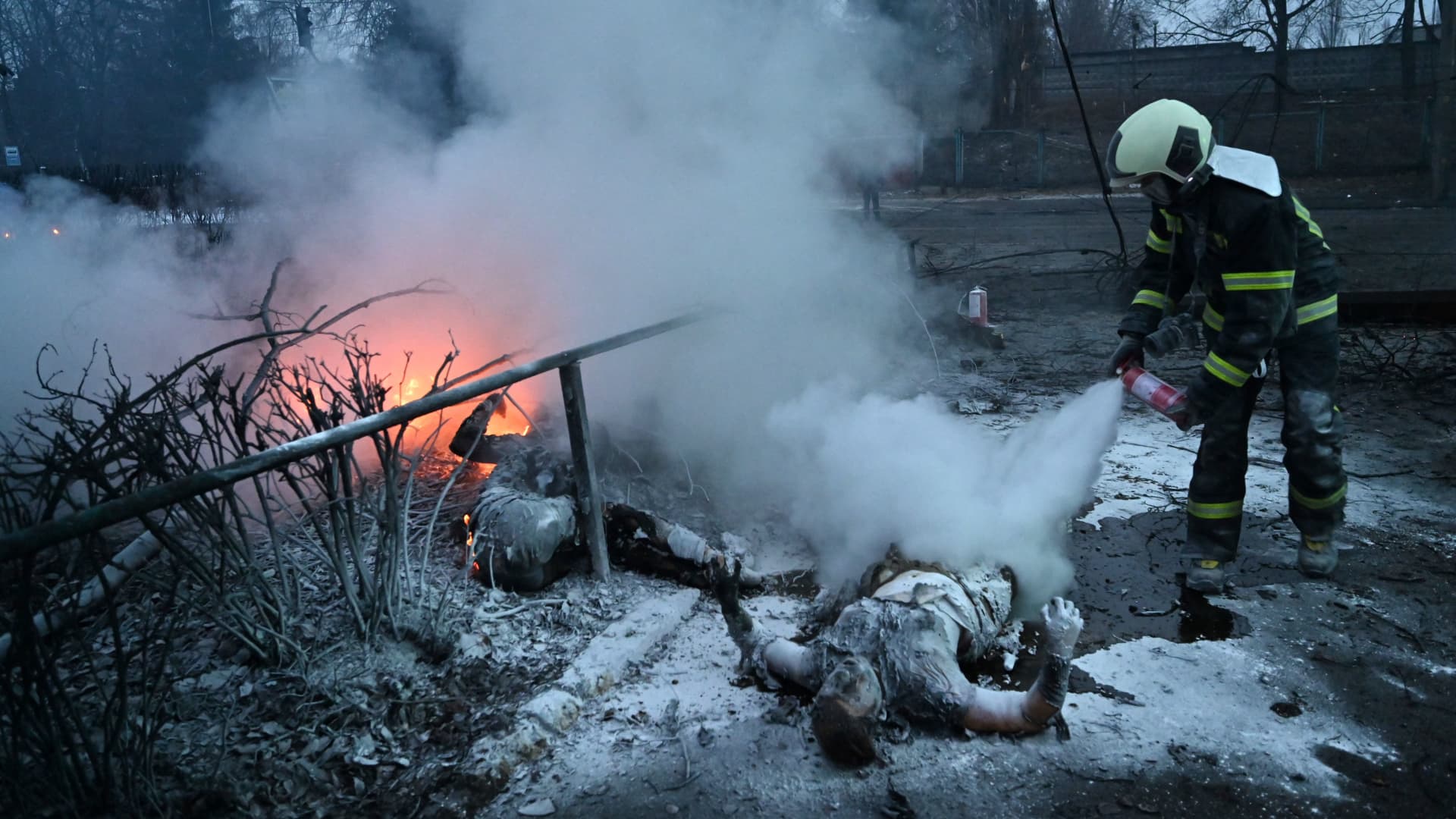 EDITORS NOTE: Graphic content: A fireman extinguishes bodies of passerbys killed after an airstrike that hit Kyiv's main television tower in Kyiv on March 1, 2022.