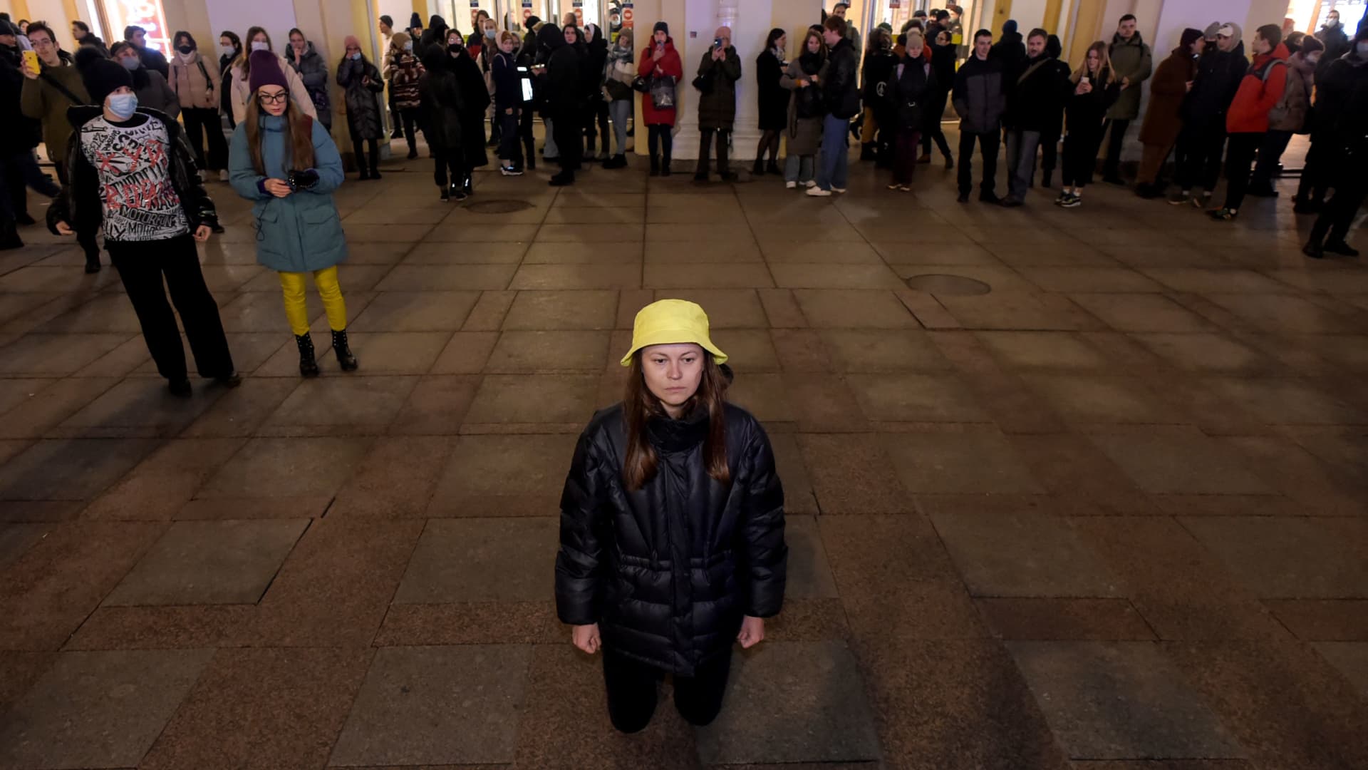 Demonstrator stands on her knees during a protest against Russia's invasion of Ukraine in central Saint Petersburg on March 1, 2022.