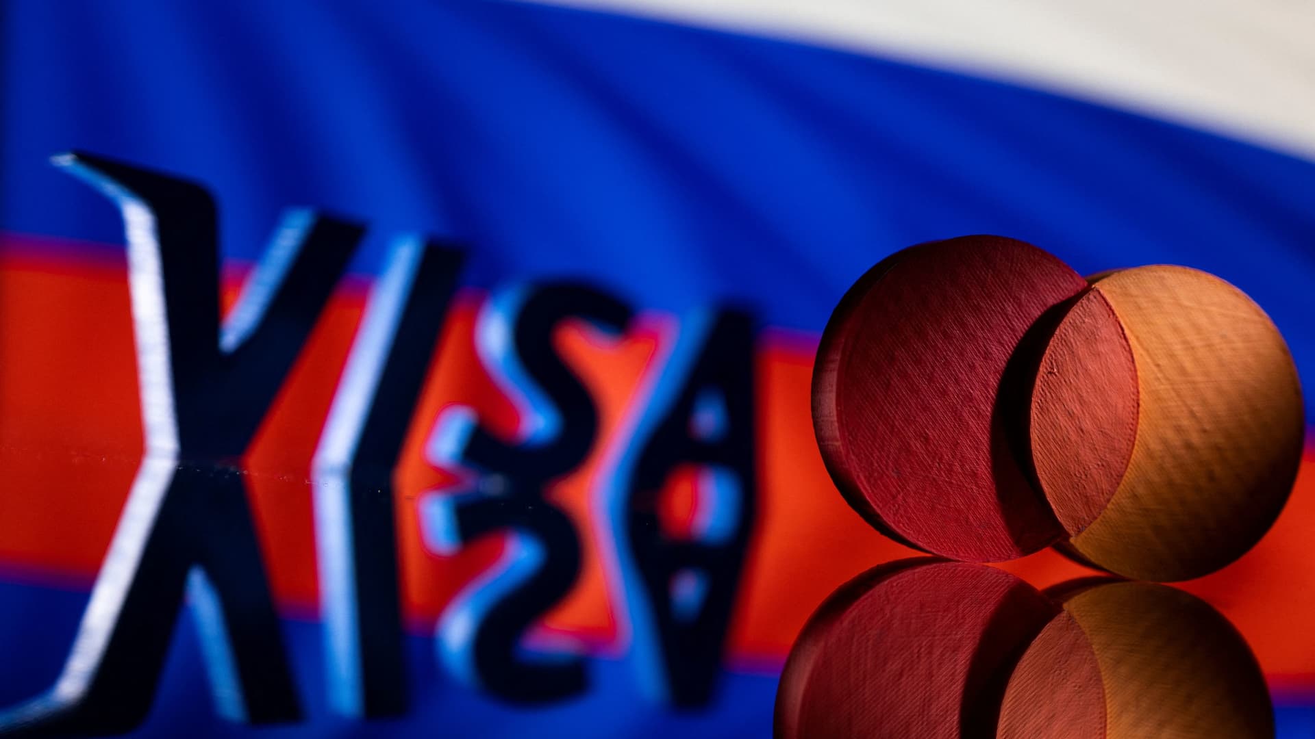 Visa and Mastercard logos are seen in front of Russian flag in this illustration taken March 1, 2022.