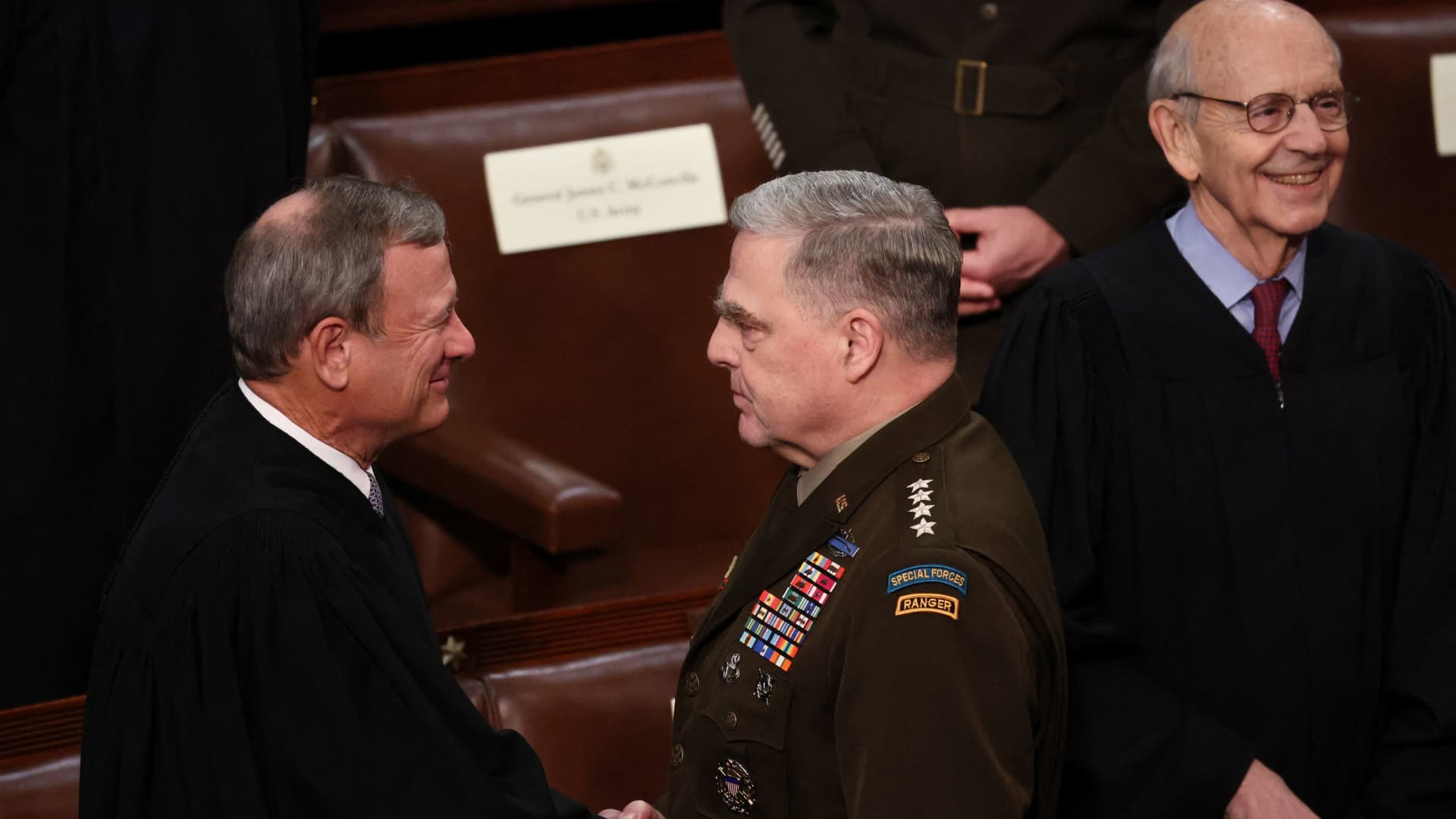 U.S. Supreme Court Chief Justice John Roberts greets Chairman of the Joint Chiefs of Staff General Mark Milley as he arrives to attend President Joe Biden's State of the Union address to a joint session of the U.S. Congress and Associate Justice Stephen Breyer looks on in the House of Representatives Chamber at the Capitol in Washington, U.S. March 1, 2022.