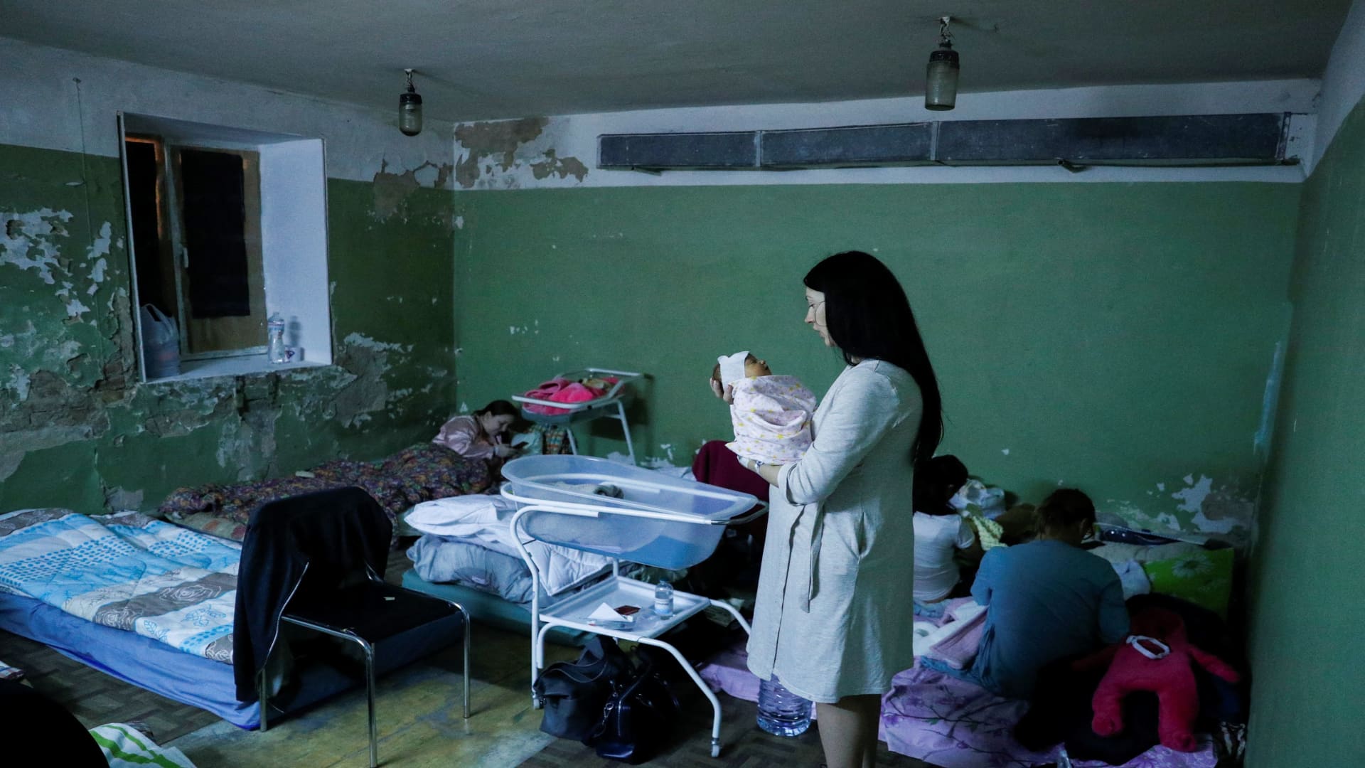 A mother holds her newborn baby in the bomb shelter of a maternity hospital on March 02, 2022 in Kyiv, Ukraine.