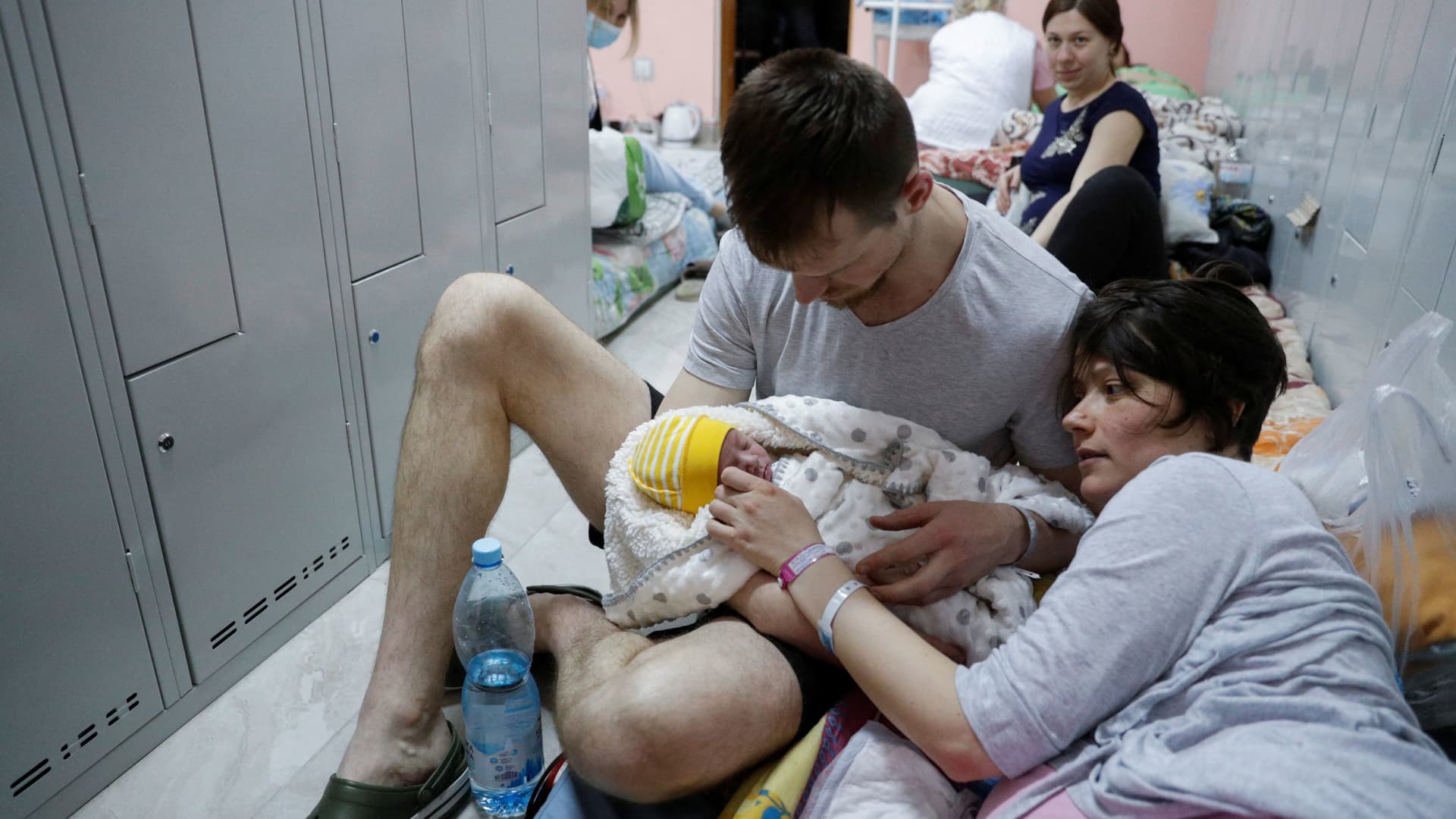 A couple with their newborn baby take shelter in the basement of a perinatal centre as air raid siren sounds are heard amid Russia's invasion of Ukraine, in Kyiv, Ukraine, March 2, 2022.
