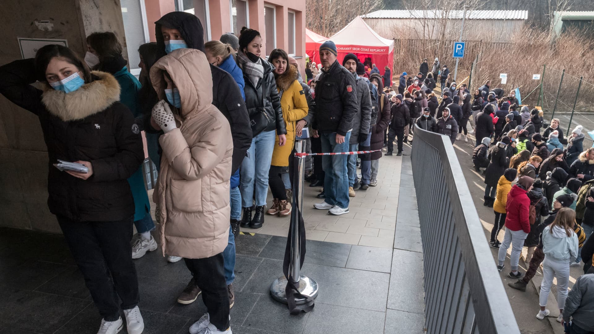 Ukrainian refugees queue to file for residence permits at Prague's foreigner police headquarters on March 2, 2022 in Prague.