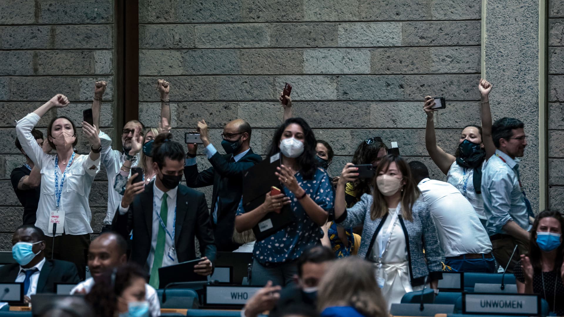 Delegates react in Nairobi, Kenya on March 02, 2022 after the United Nations agreed to start negotiating a world-first global treaty on plastic pollution.