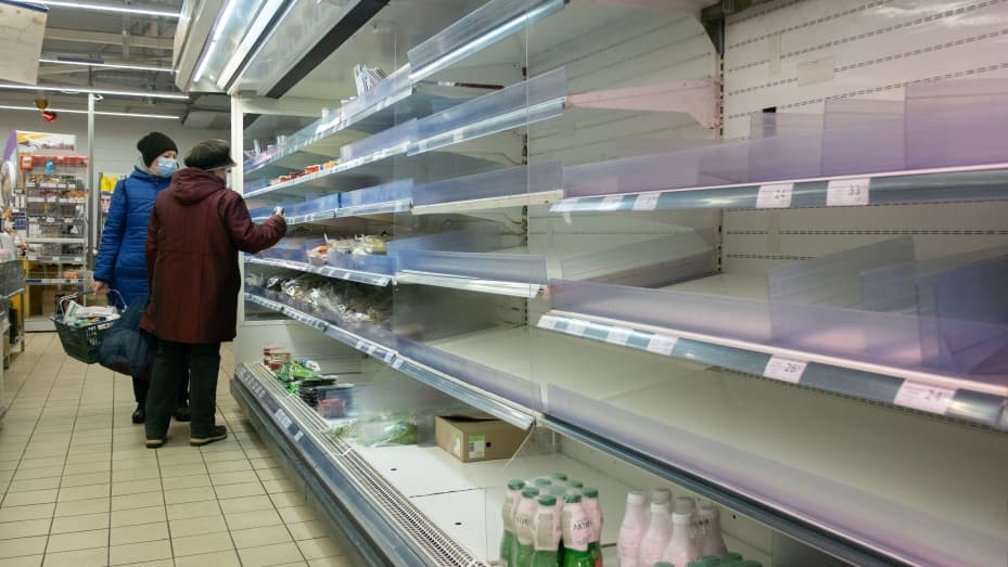 Local residents are seen in front of partially empty shelves at a supermarket in Kyiv, Ukraine March 3, 2022.