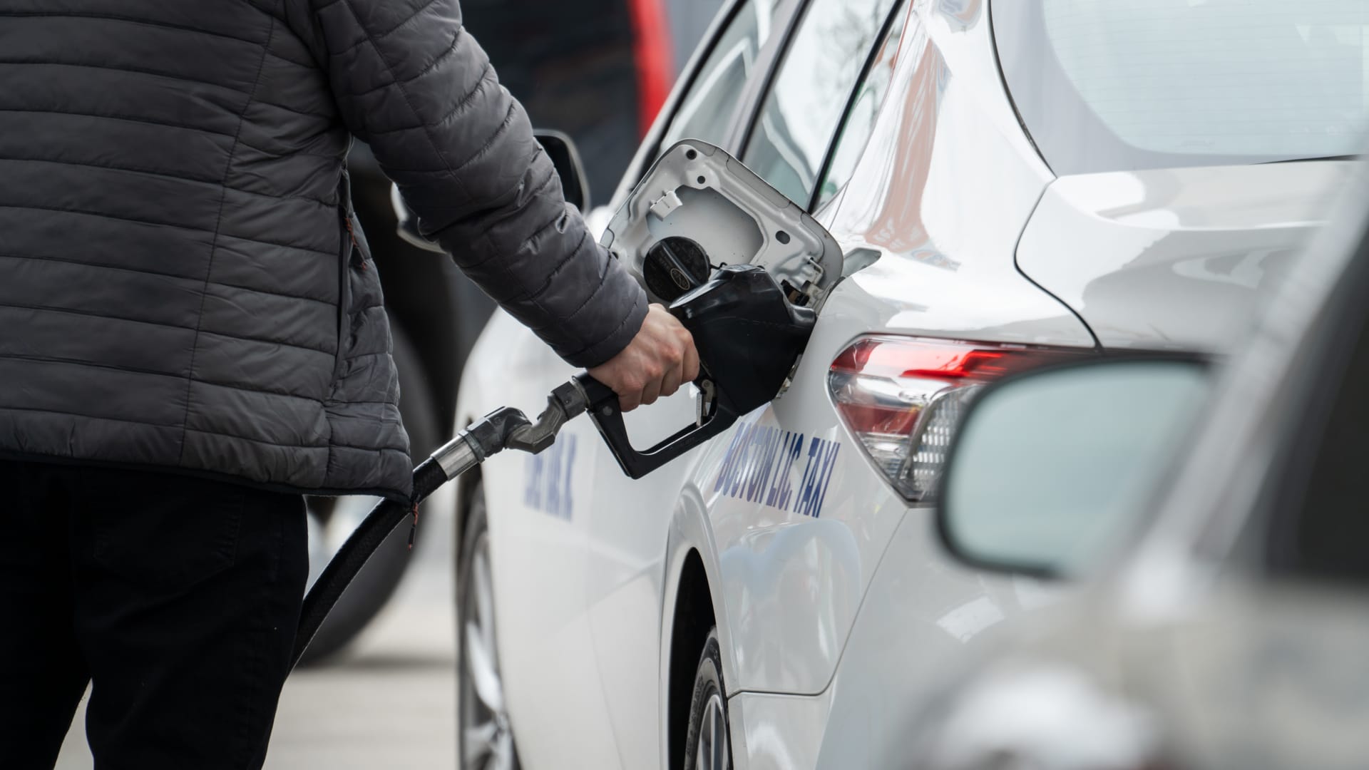 A taxi driver refuels a vehicle at a Gulf gas station in Boston on March 1, 2022.