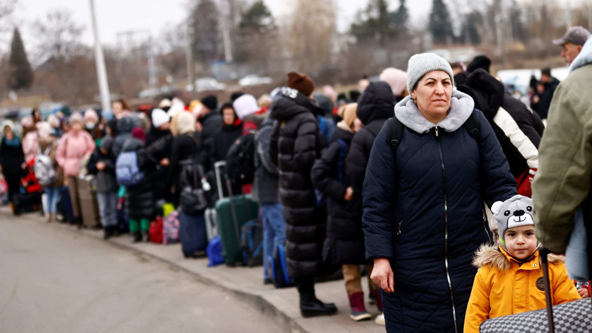 People wait to board a bus after fleeing the Russian invasion of Ukraine, at the border checkpoint in Medyka, Poland, March 4, 2022.