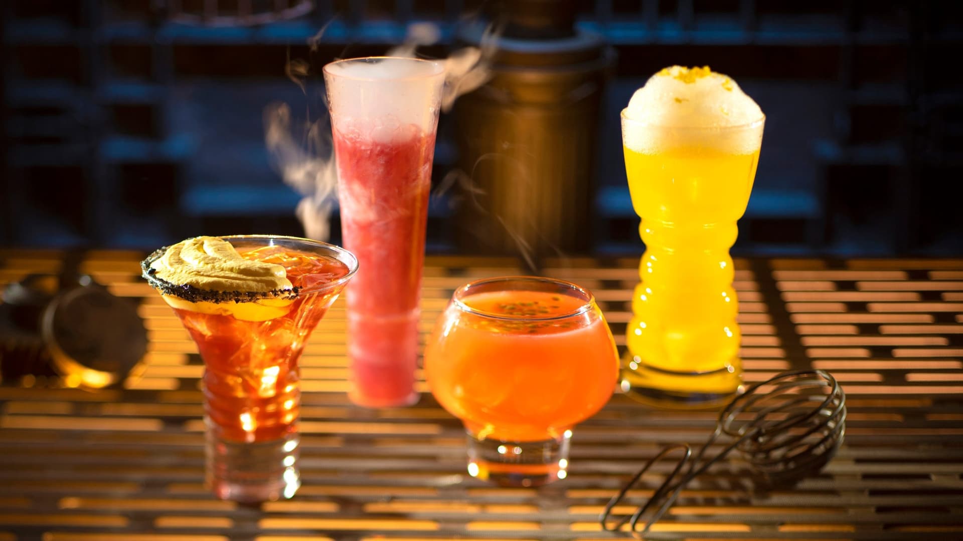 From left to right, alcoholic beverages: The Outer Rim, Bespin Fizz, Yub Nub, and Fuzzy Tauntaun can be found at Oga's Cantina in Star Wars: Galaxy's Edge at Disneyland Park in Anaheim, California and at Disney's Hollywood Studios in Lake Buena Vista, Florida.