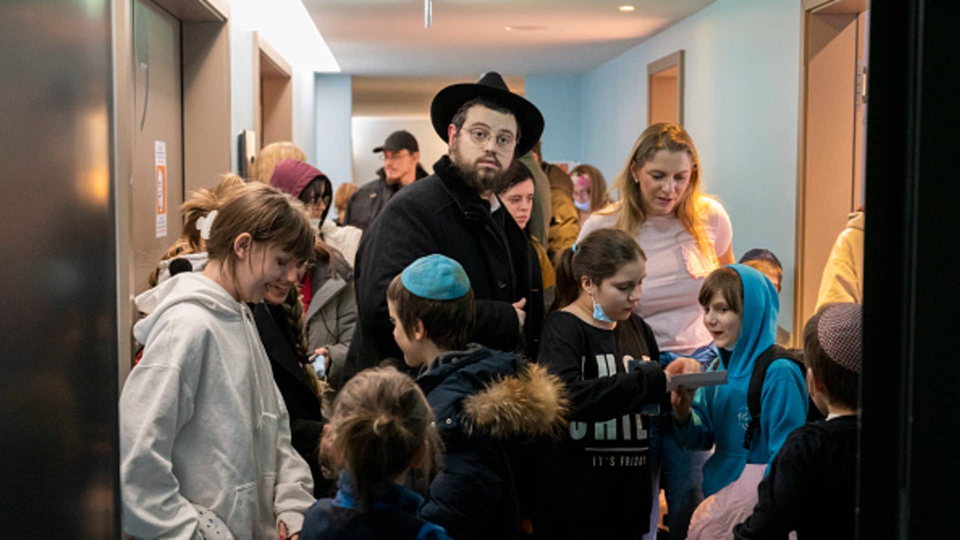 Mendi Wolff, son of the Chief Rabbi of Odessa and Southern Ukraine, stands in a hallway in a hotel among children from an orphanage in Odessa, Ukraine. Two buses with children from an orphanage in Odessa have arrived in Berlin.