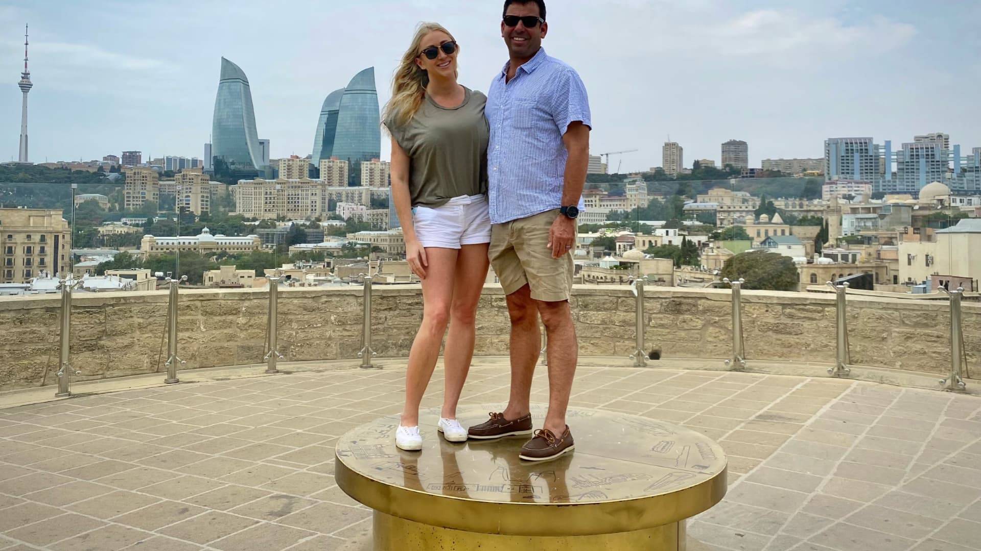 Miller and Feldman, standing in Baku, Azerbaijan, spend seven months of the year traveling. Their goal is to visit every country on Earth.