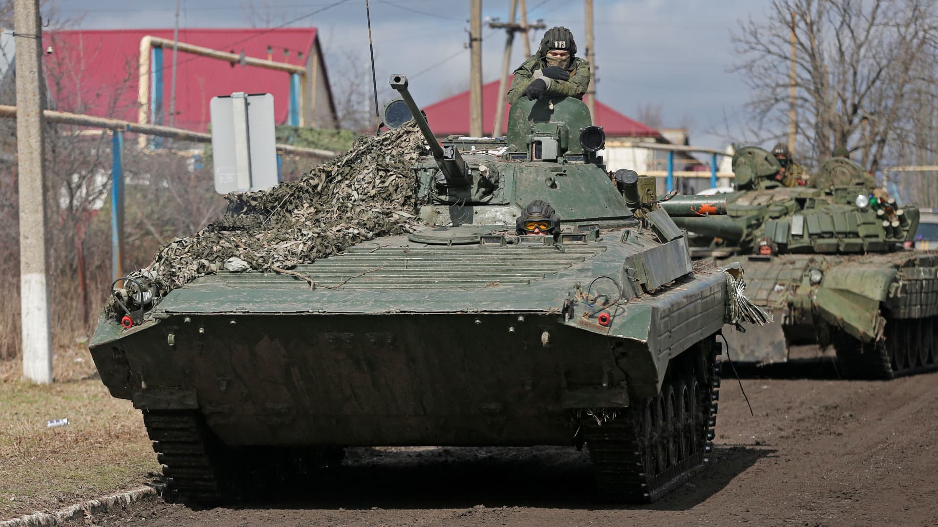 Service members of pro-Russian troops in uniforms without insignia drive an armoured vehicle in the separatist-controlled village of Bugas during Ukraine-Russia conflict in the Donetsk region, Ukraine March 6, 2022.