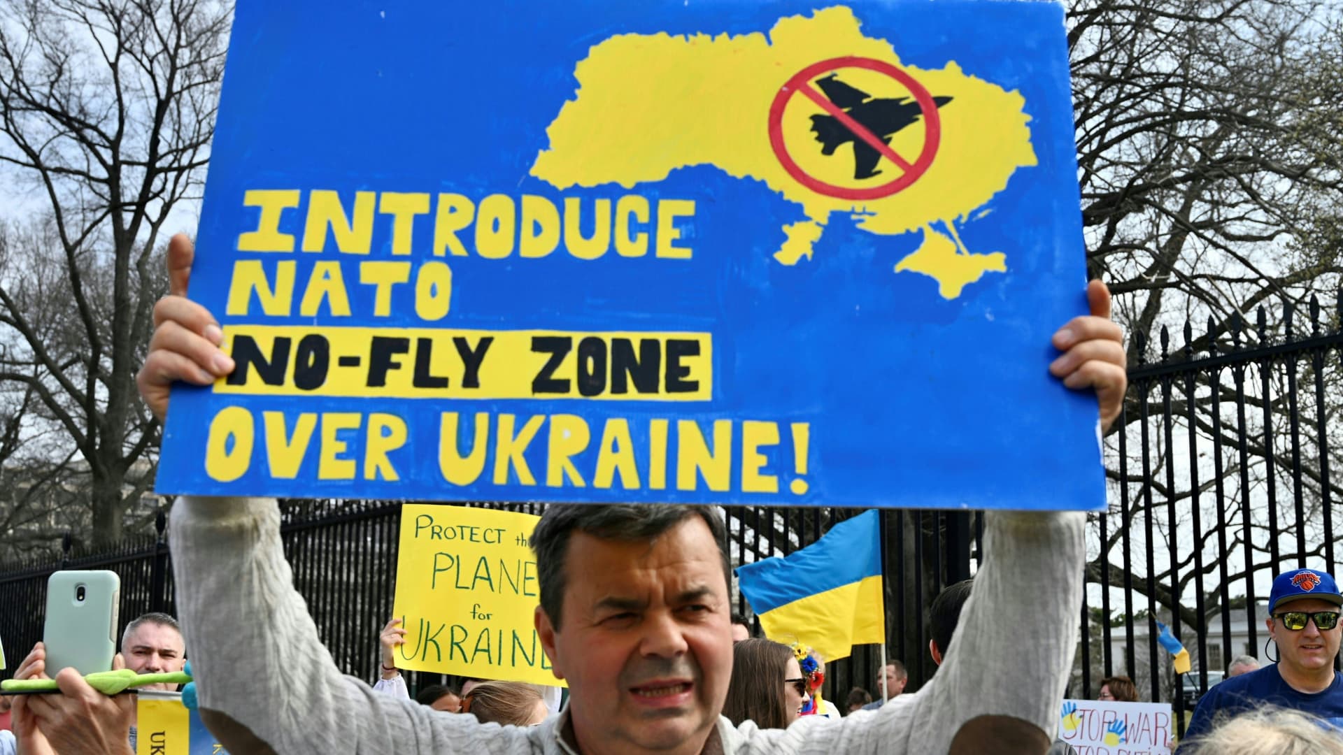 Supporters hold up signs during a rally protesting the Russian invasion of Ukraine at Lafayette Square across the White House in Washington, DC, on March 6, 2022.