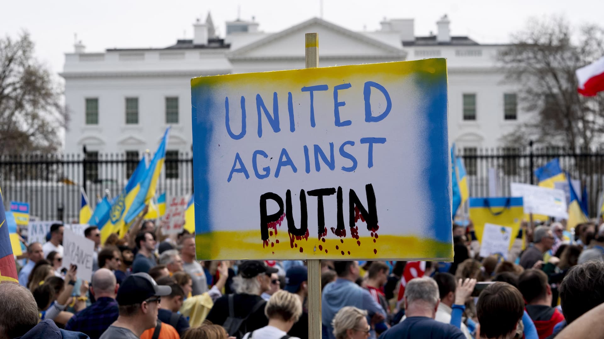 A demonstrator holds a United Against Putin sign outside the White House in Washington, DC, on March 6, 2022, during a rally in support of Ukraine.