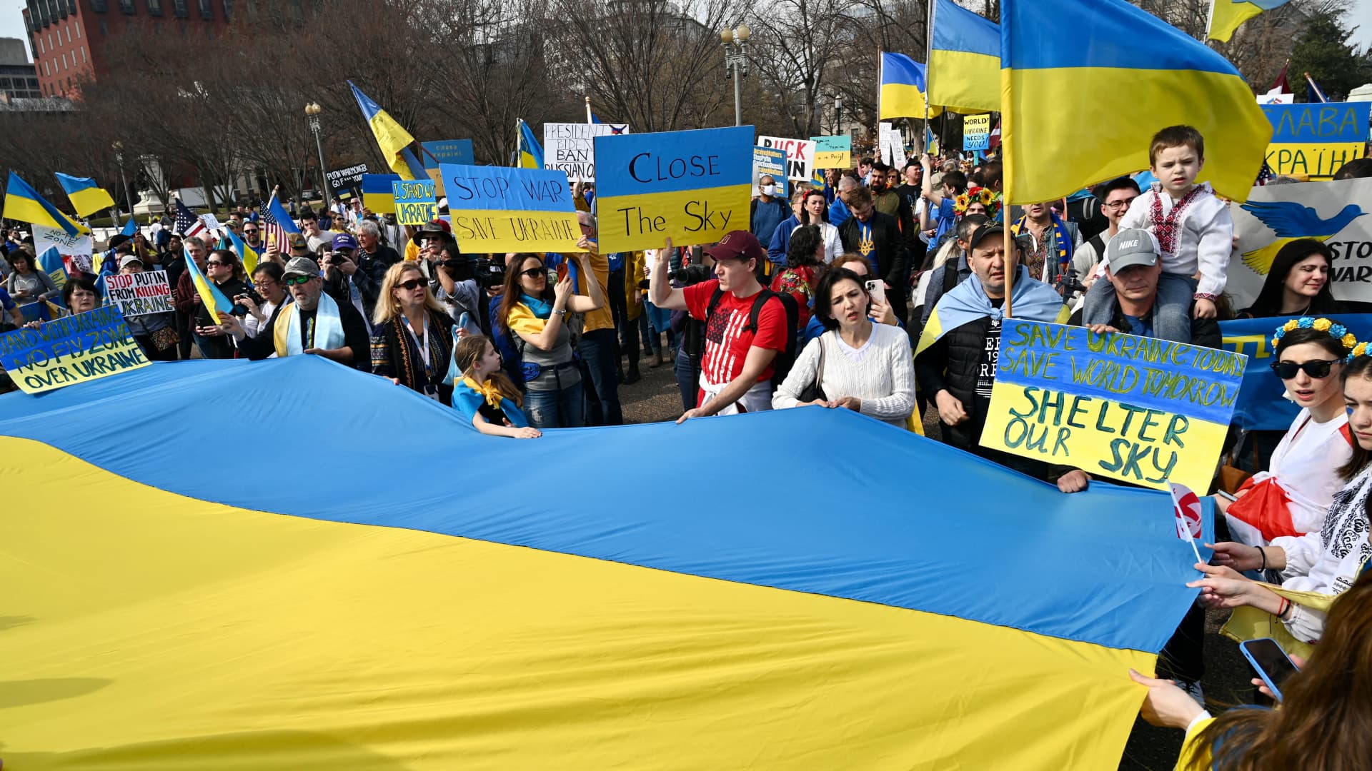 Supporters hold up signs and Ukrainian flags during a rally protesting the Russian invasion of Ukraine at Lafayette Square across the White House in Washington, DC, on March 6, 2022.