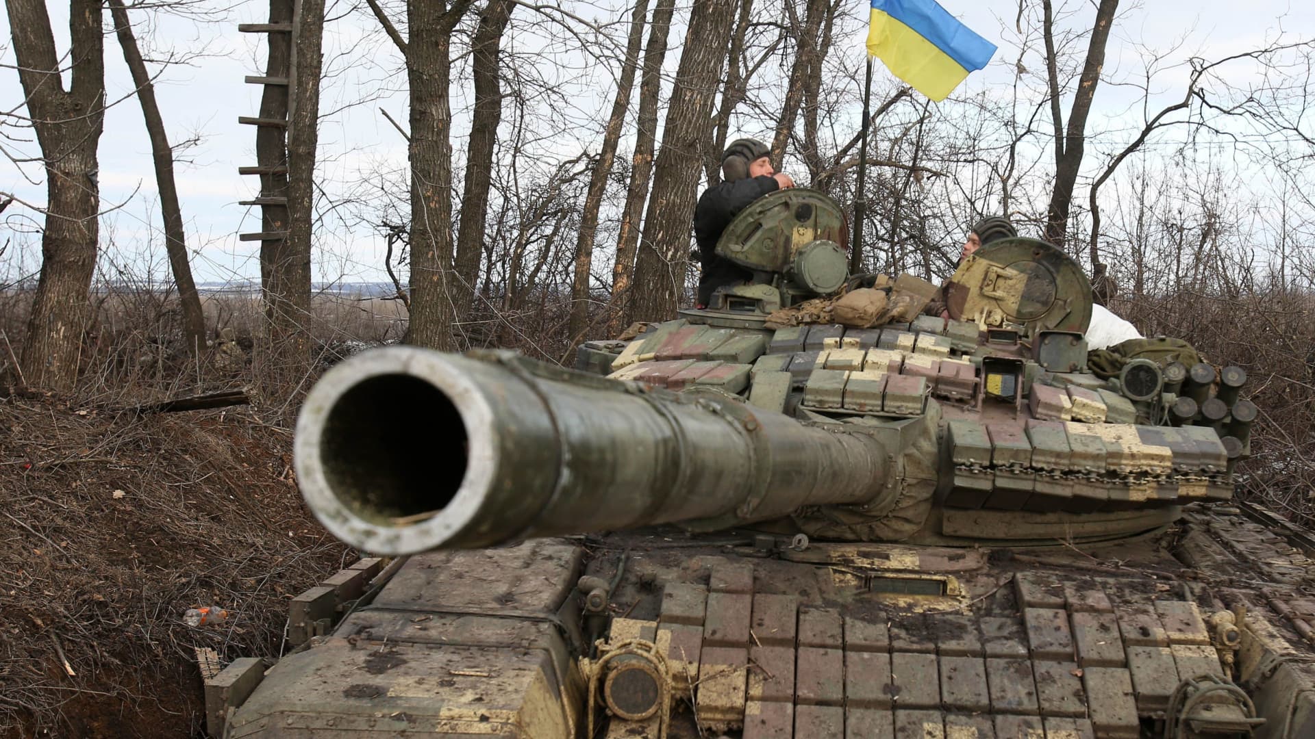 Two Ukrainian servicemen speak atop a tank following a battle against Russian troops and Russia-backed separatists near Zolote village, Lugansk region on March 6, 2022.