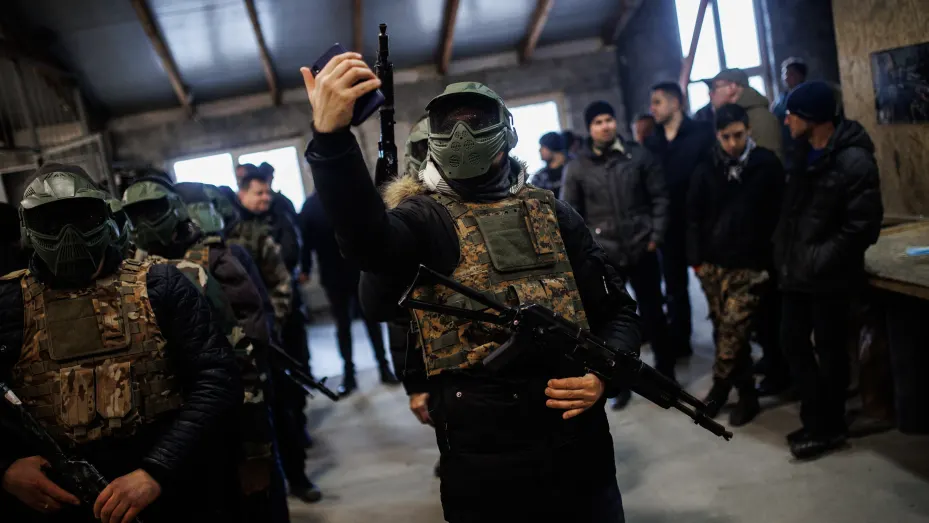 Civilians and soldiers with assault rifles during training on March 5, 2022, in Lviv, Ukraine.