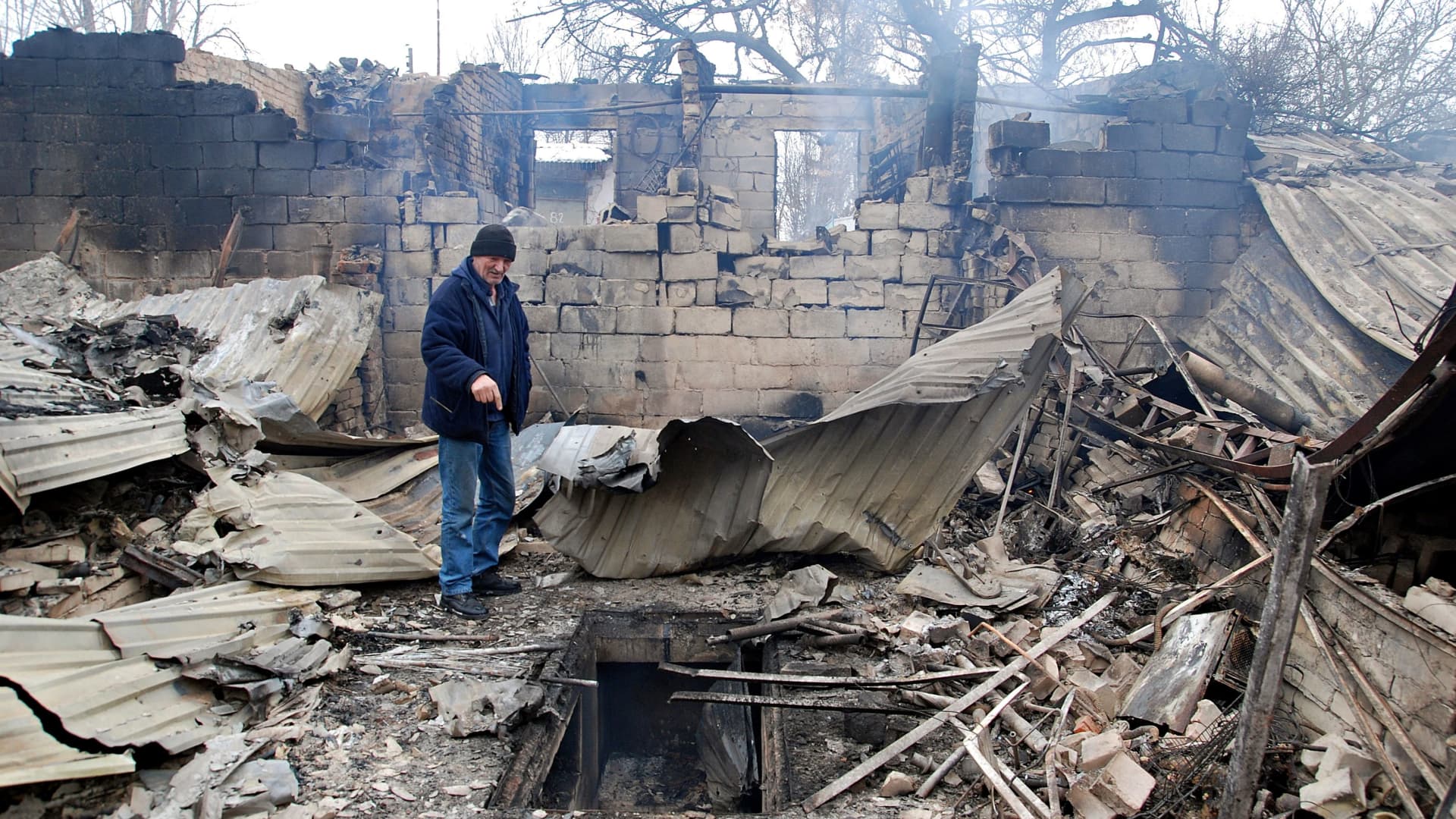 A man stands on the rubble of a house destroyed by recent shelling during Ukraine-Russia conflict in Kharkiv, Ukraine March 7, 2022.
