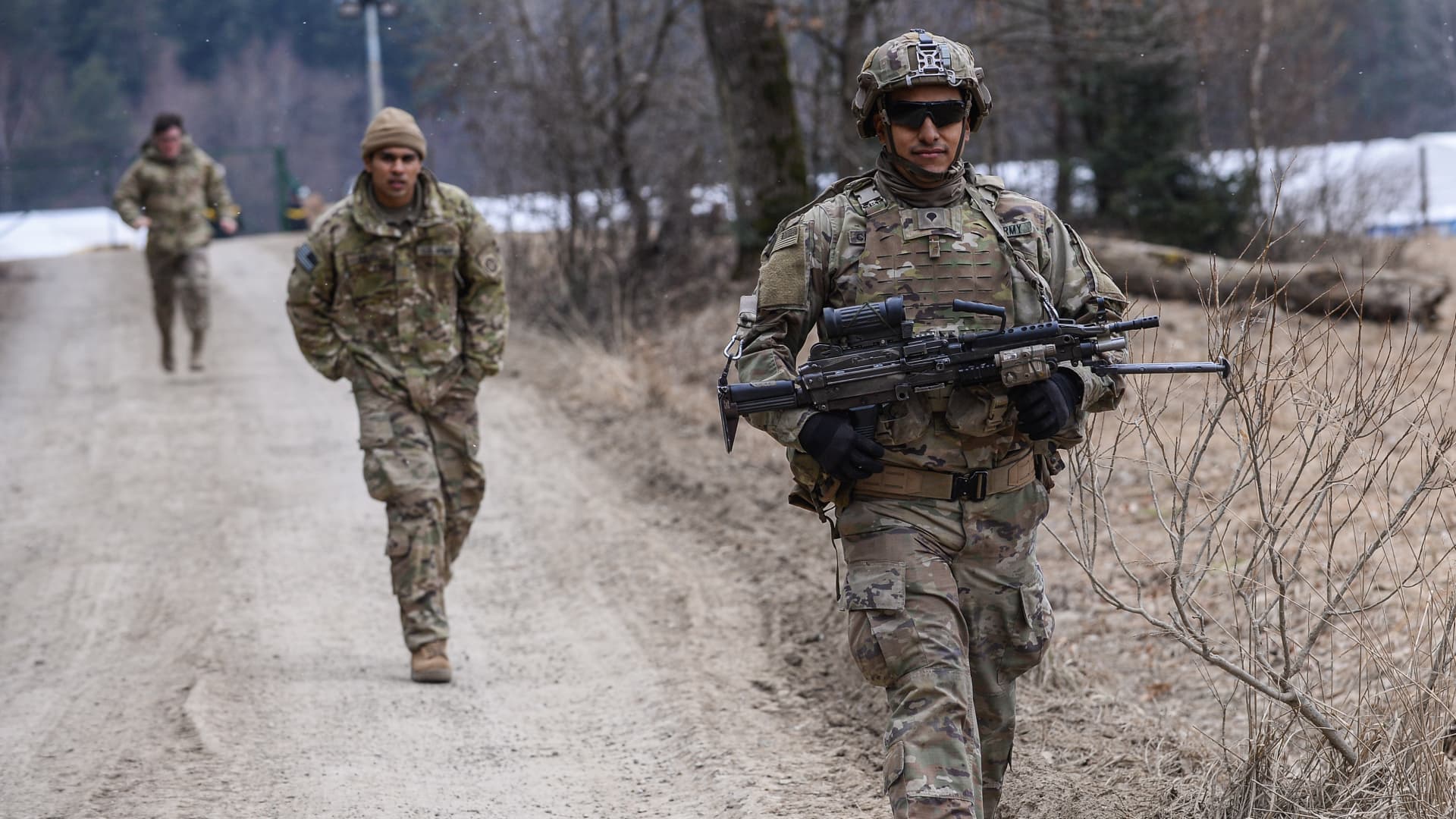 U.S. Army soldiers assigned to the 82nd Airborne carry military equipment as they take part in an exercise outside the operating base at the Arlamow Airport on March 7th, 2022 in Wola Korzeniecka, Poland.