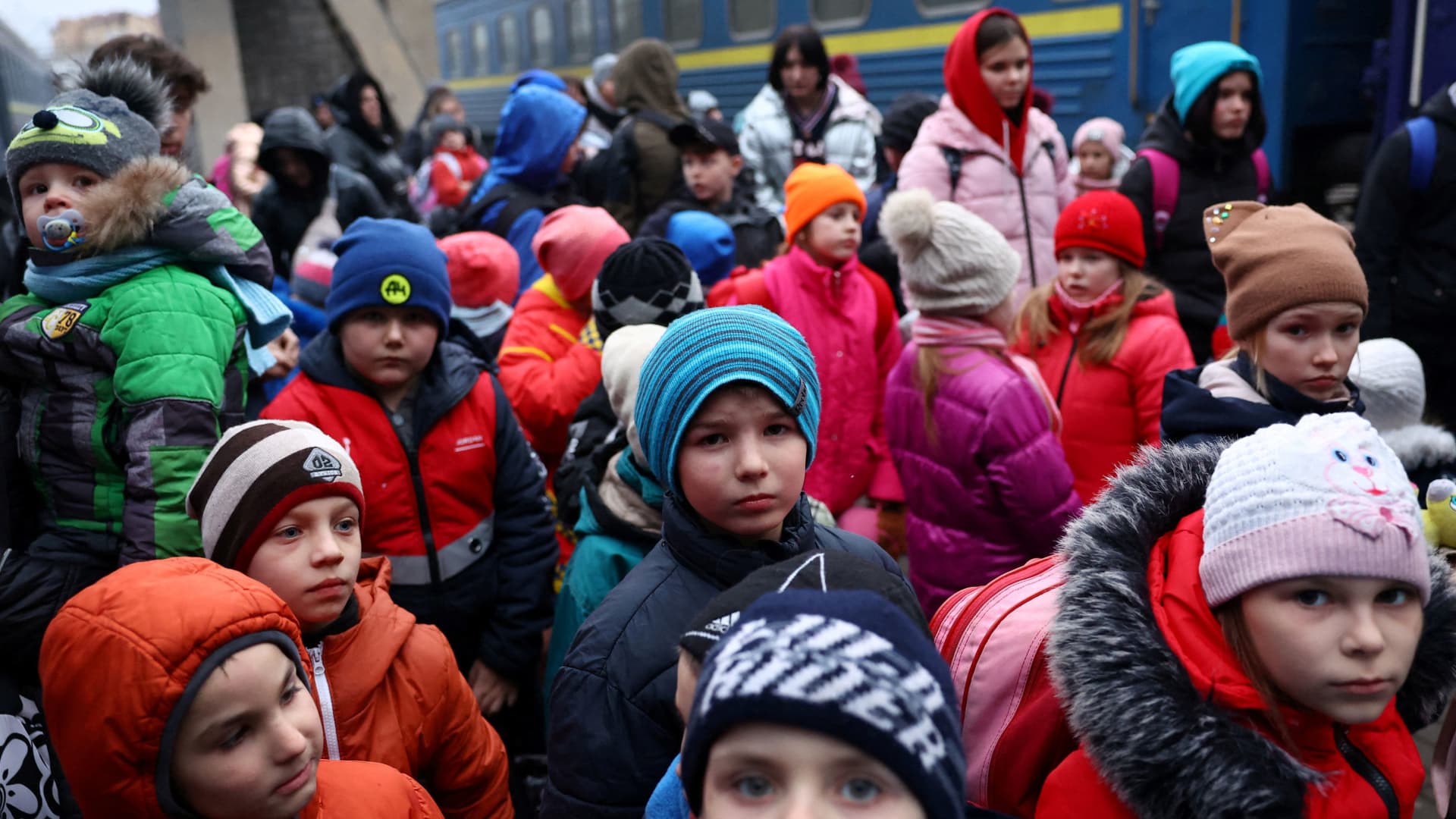 A group of children evacuated from an orphanage in Zaporizhzhia wait to board a bus for their transfer to Poland after fleeing the ongoing Russian invasion at the main train station in Lviv, Ukraine, March 5, 2022.