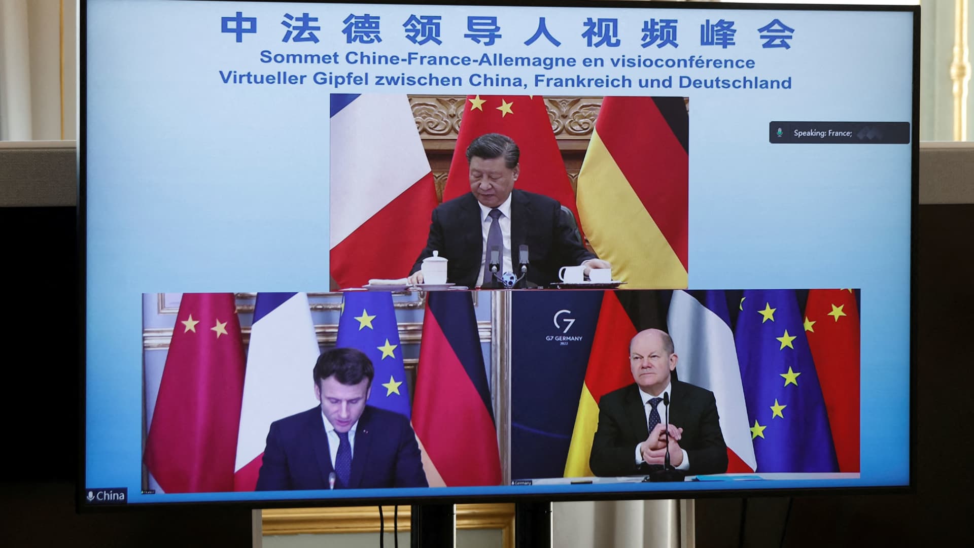 A video screen displays French President Emmanuel Macron, German Chancellor Olaf Scholz and Chinese President Xi Jinping attending a video-conference to discuss the Ukraine crisis, at the Elysee Palace in Paris, on March 8, 2022.