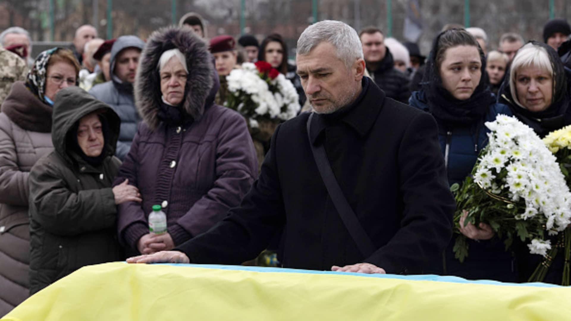 Father of Ivan, Yuriy, pauses over his sons coffin during a service at Lychakiv cemetery during a joint funeral for two soldiers who died in the east of the country during recent fighting, on March 08, 2022 in Lviv, Ukraine.