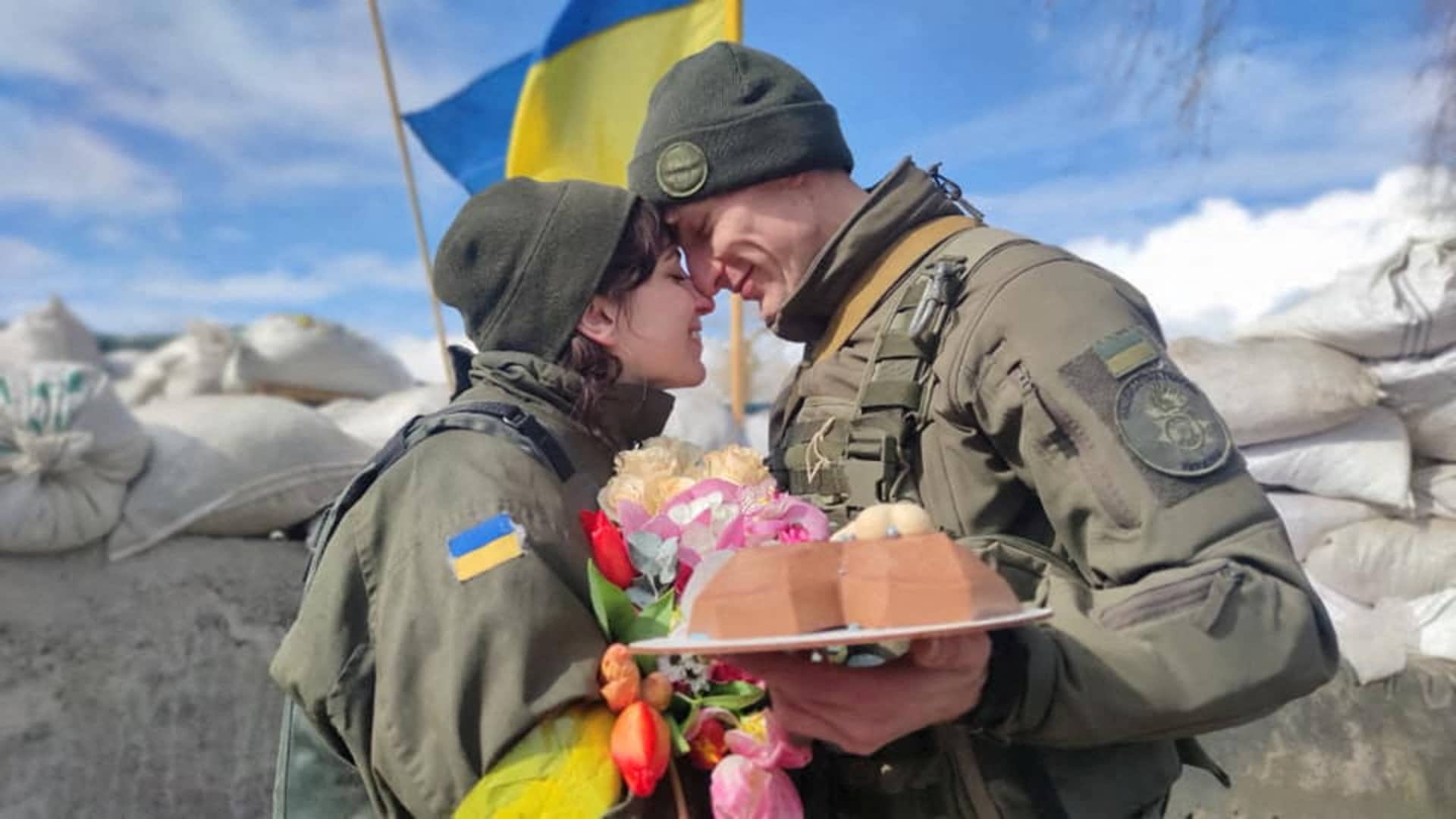 Members of the National Guard of Ukraine Oleksandr and Olena react at their wedding during Ukraine-Russia conflict, at a checkpoint in unknown location, in Ukraine, in this handout picture released March 8, 2022.