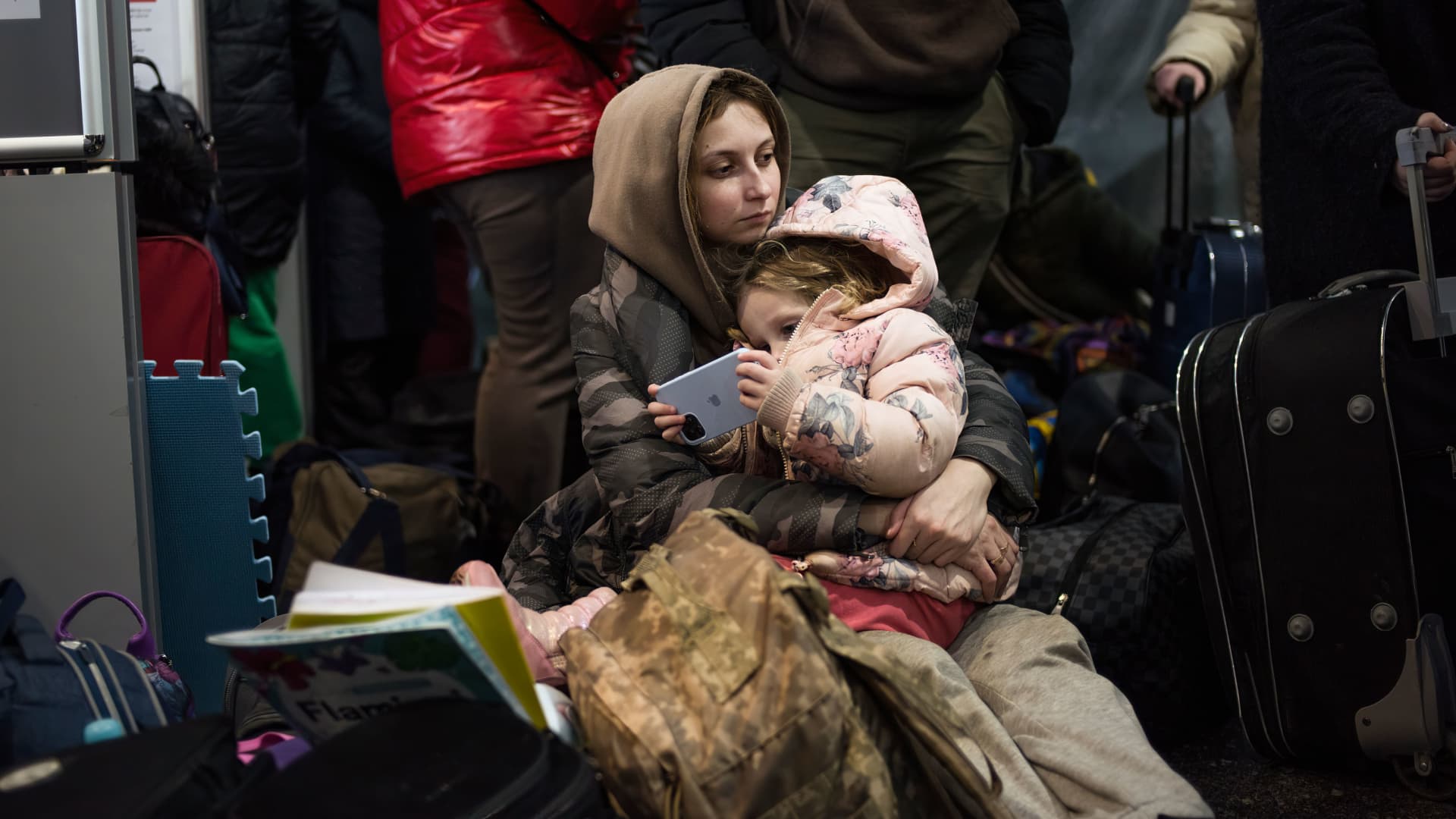A woman seen carrying her baby at the Central Train Station in Warsaw, Poland, March 8, 2022.