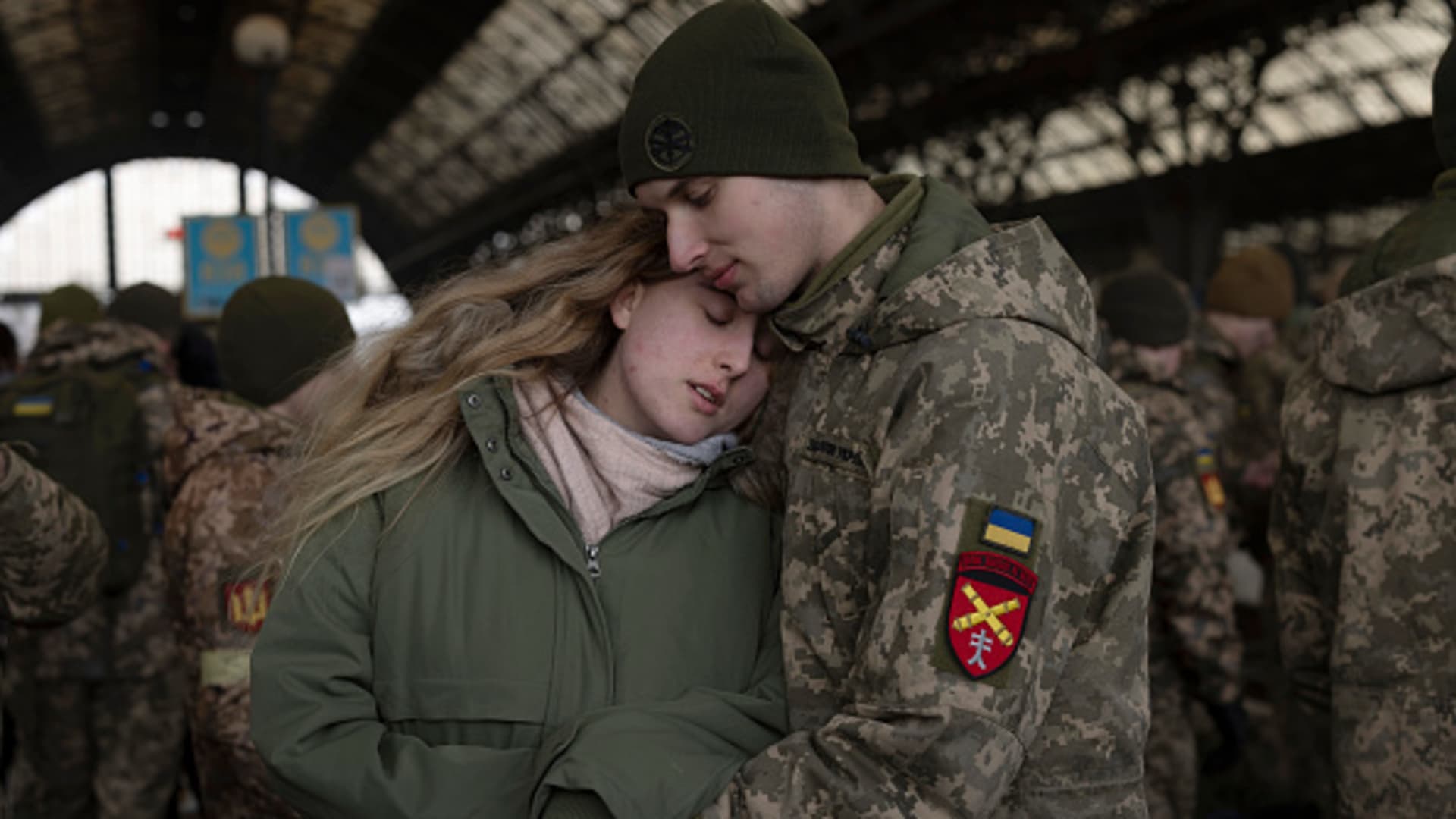 Eugene says goodbye to his partner Tanya before boarding a train to Dnipro from the main train terminal on March 09, 2022 in Lviv, Ukraine.