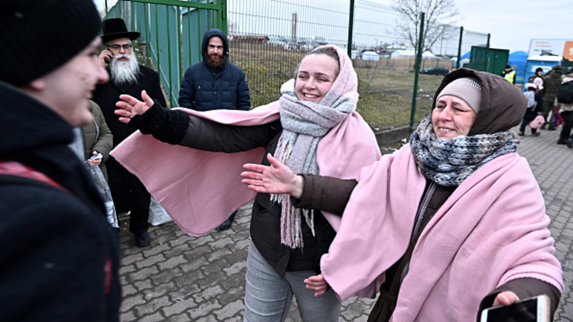 Ukrainian refugee Orest Hromnadzkiy gets a hug from his sister Yuliia and mother Alla after he crossed the border in Medyka, Poland, March 9, 2022.
