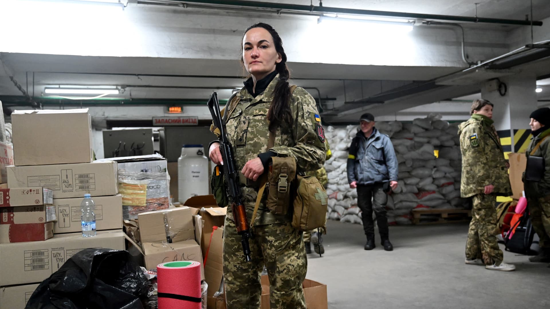 Iryna Sergeyeva, Ukraine's first female volunteer fighter to get a full military contract of the Territorial Defense Forces of Ukraine, the military reserve of the Armed Forces of Ukraine, holds her Kalashnikov mashine-gun as she attends a military training in an underground garage that has been converted into a training and logistics base in Kyiv, on March 11, 2022.