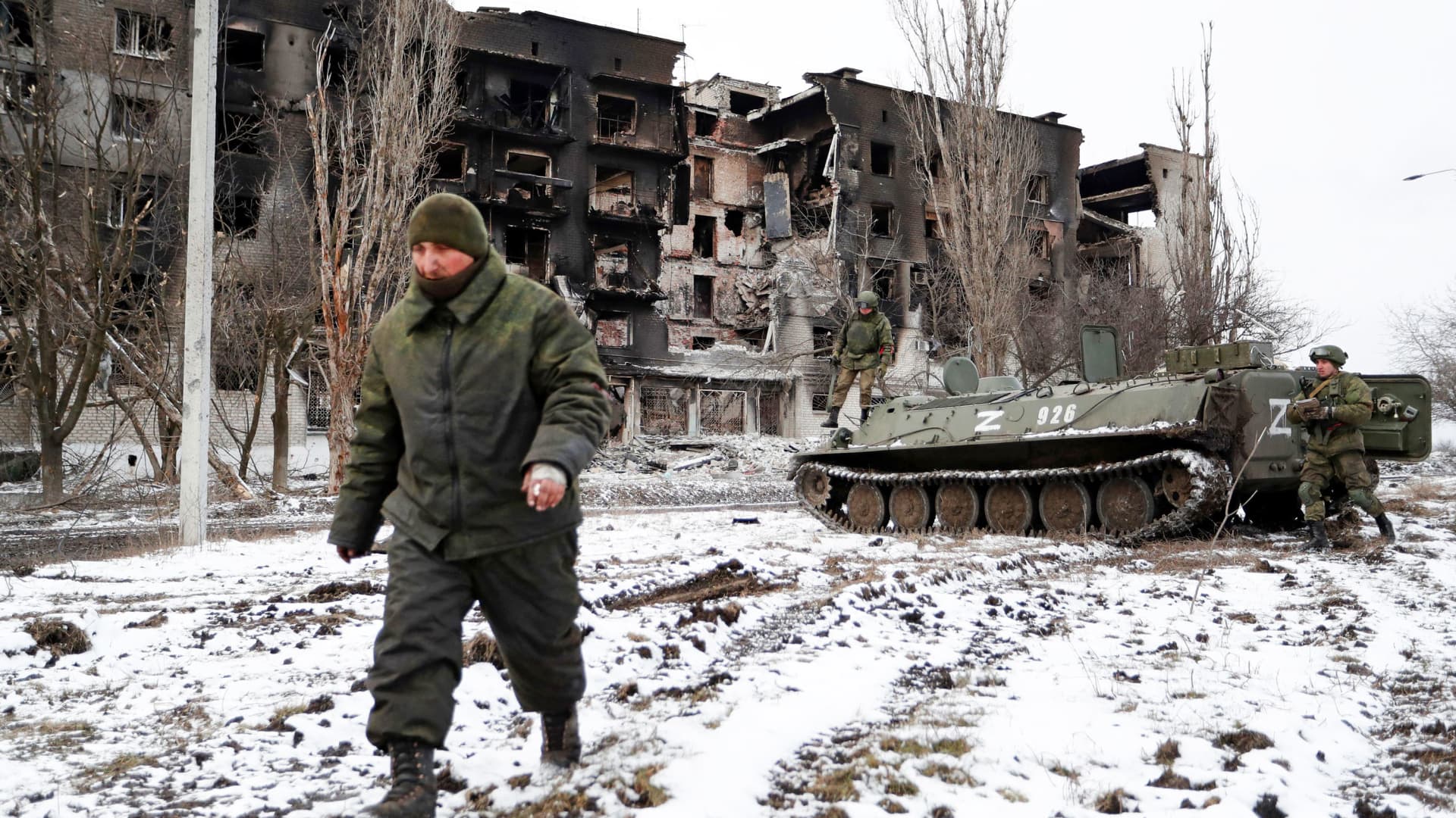 Service members of pro-Russian troops in uniforms without insignia are seen near a residential building which was heavily damaged during Ukraine-Russia conflict in the separatist-controlled town of Volnovakha in the Donetsk region, Ukraine March 11, 2022.