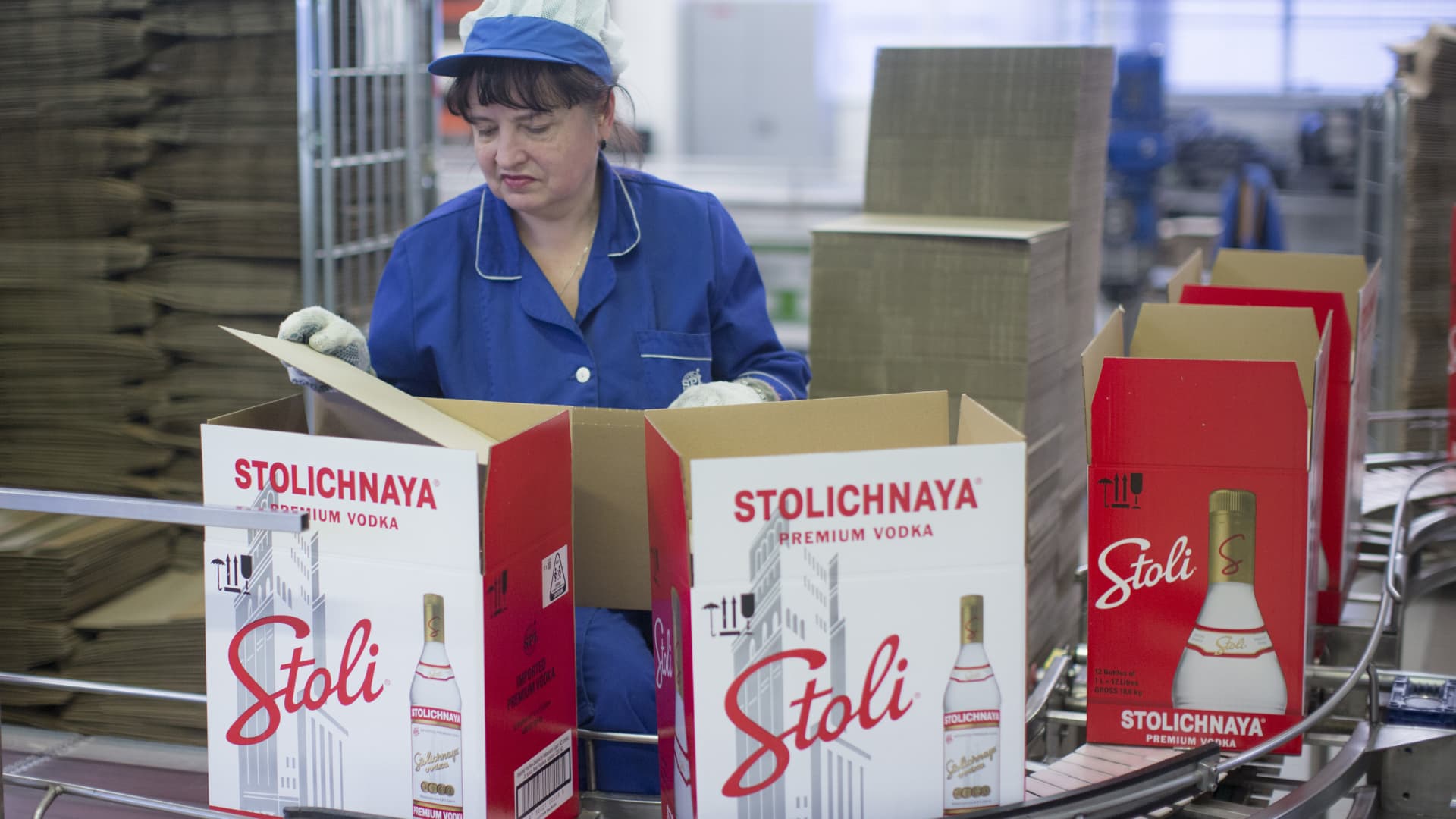 Workers prepare shipping boxes for Stolichnaya vodka, operated by the SPI Group, on the production line in Riga, Latvia.