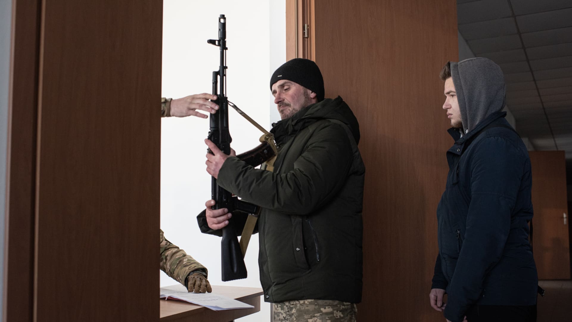 A civilian checks out an assault rife for a military training exercise conducted by the Prosvita society in Ivano-Frankivsk, Ukraine, on Friday, March 11, 2022.