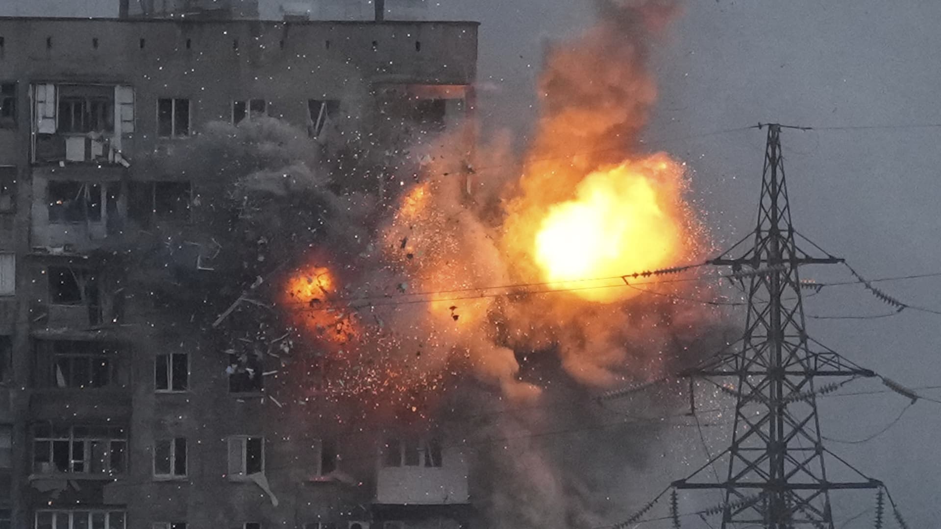 An explosion in an apartment building that came under fire from a Russian army tank in Mariupol, Ukraine, Friday, March 11, 2022.