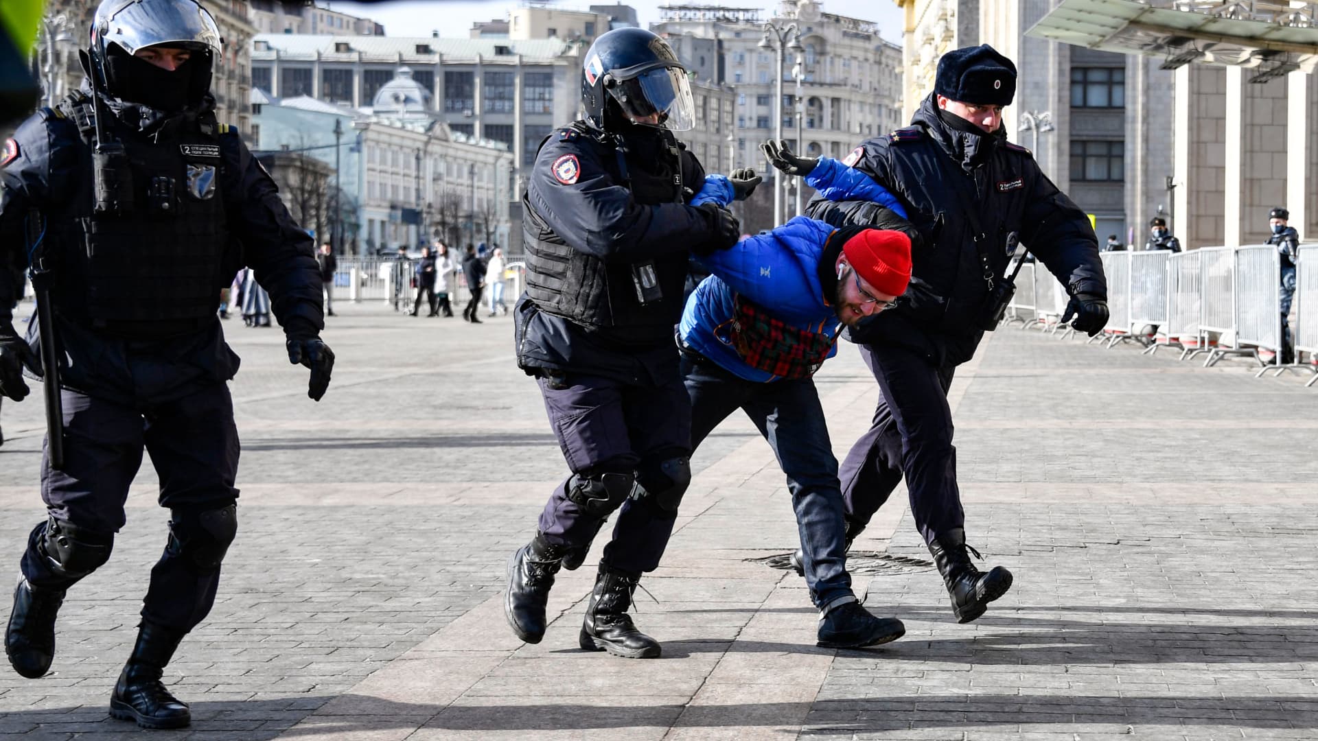 Police officers detain a man during a protest against Russian military action in Ukraine, in Manezhnaya Square in central Moscow on March 13, 2022.