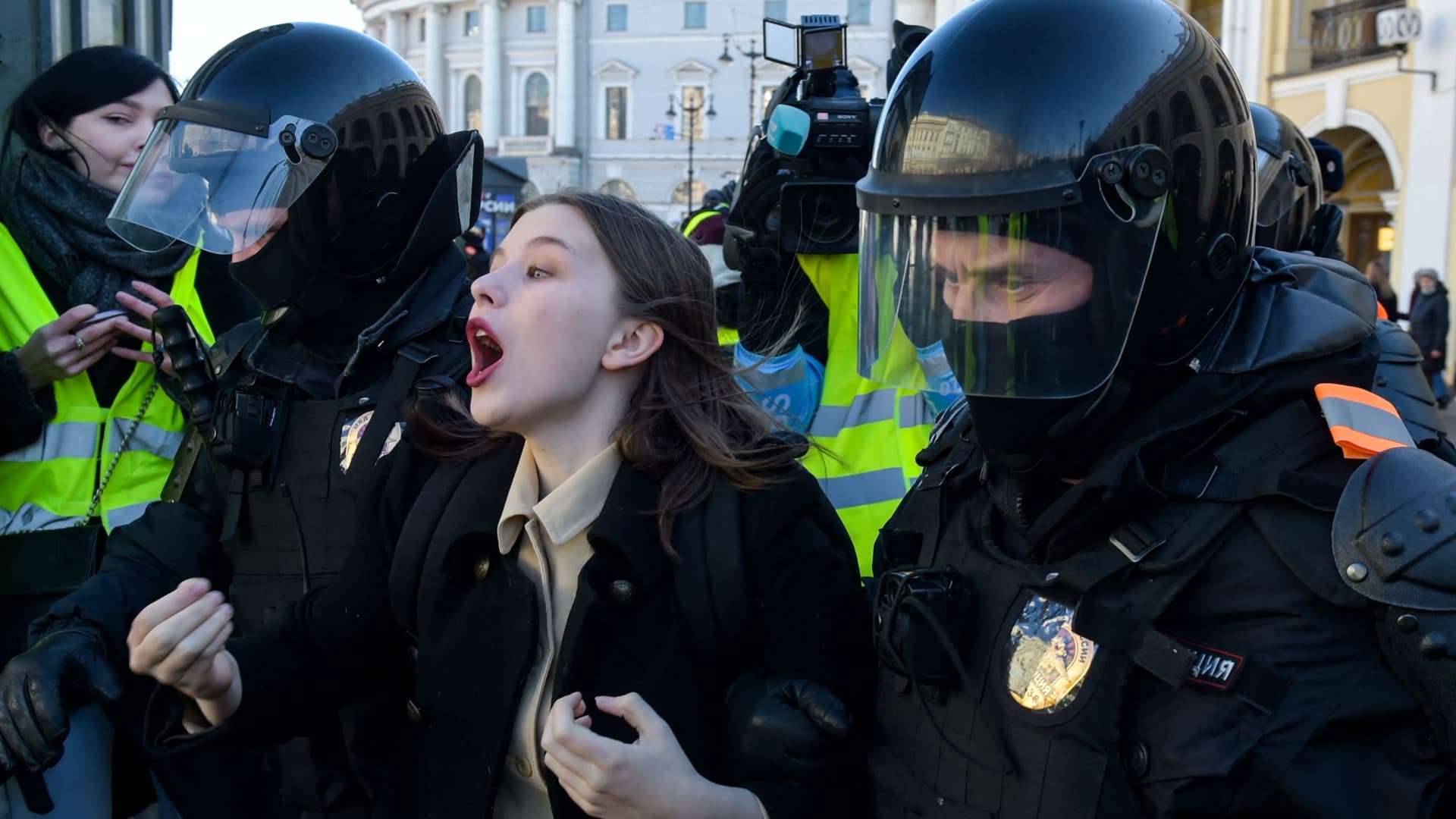 Police officers detain a woman during a protest against Russian military action in Ukraine, in central Saint Petersburg on March 13, 2022.