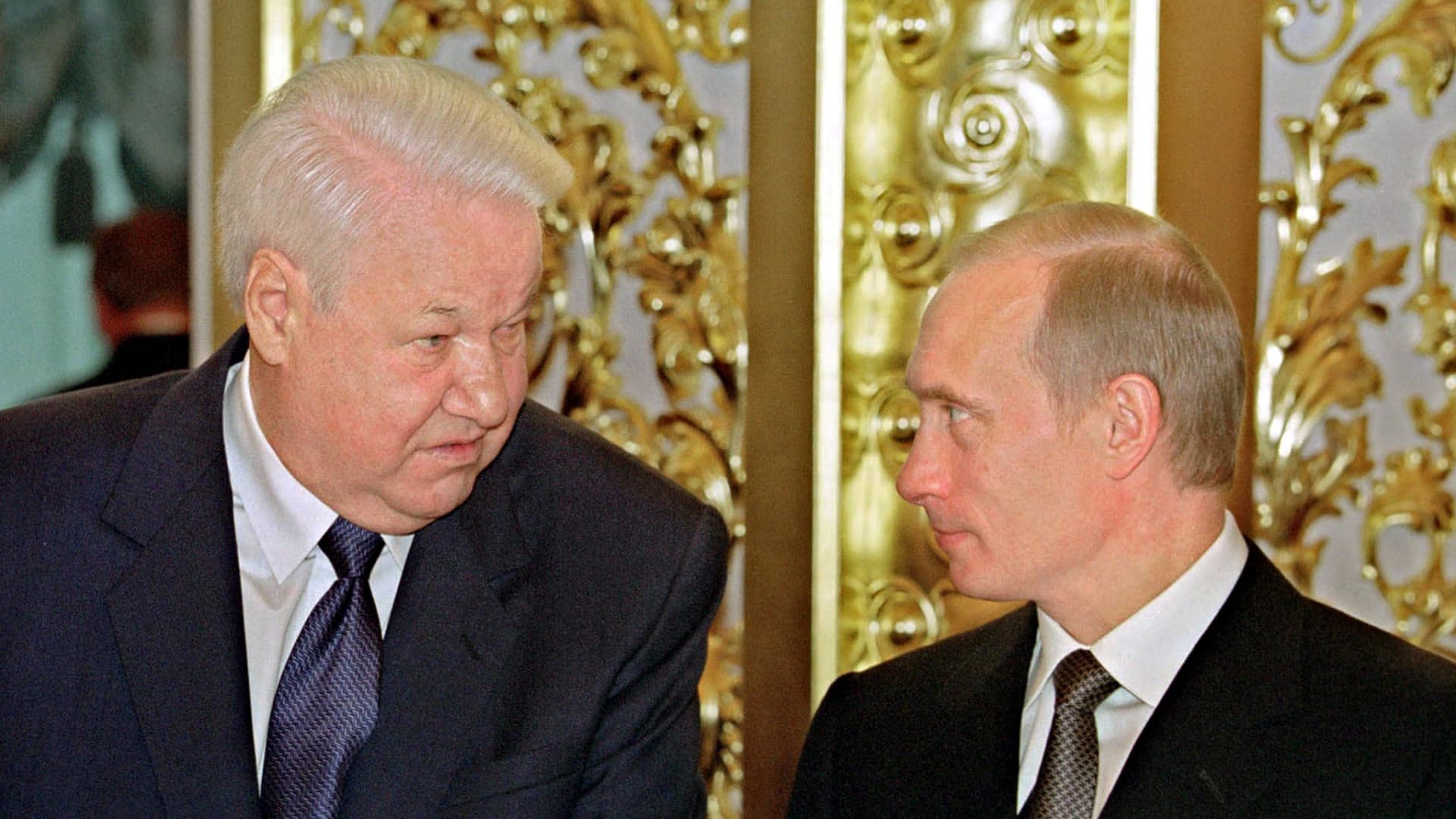 Russian President Vladimir Putin chats with the first President of Russia, Boris Yeltsin, during the State reception in Kremlin, devoted to the Day of Declaration of Sovereignty in Moscow, 12 June 2001.