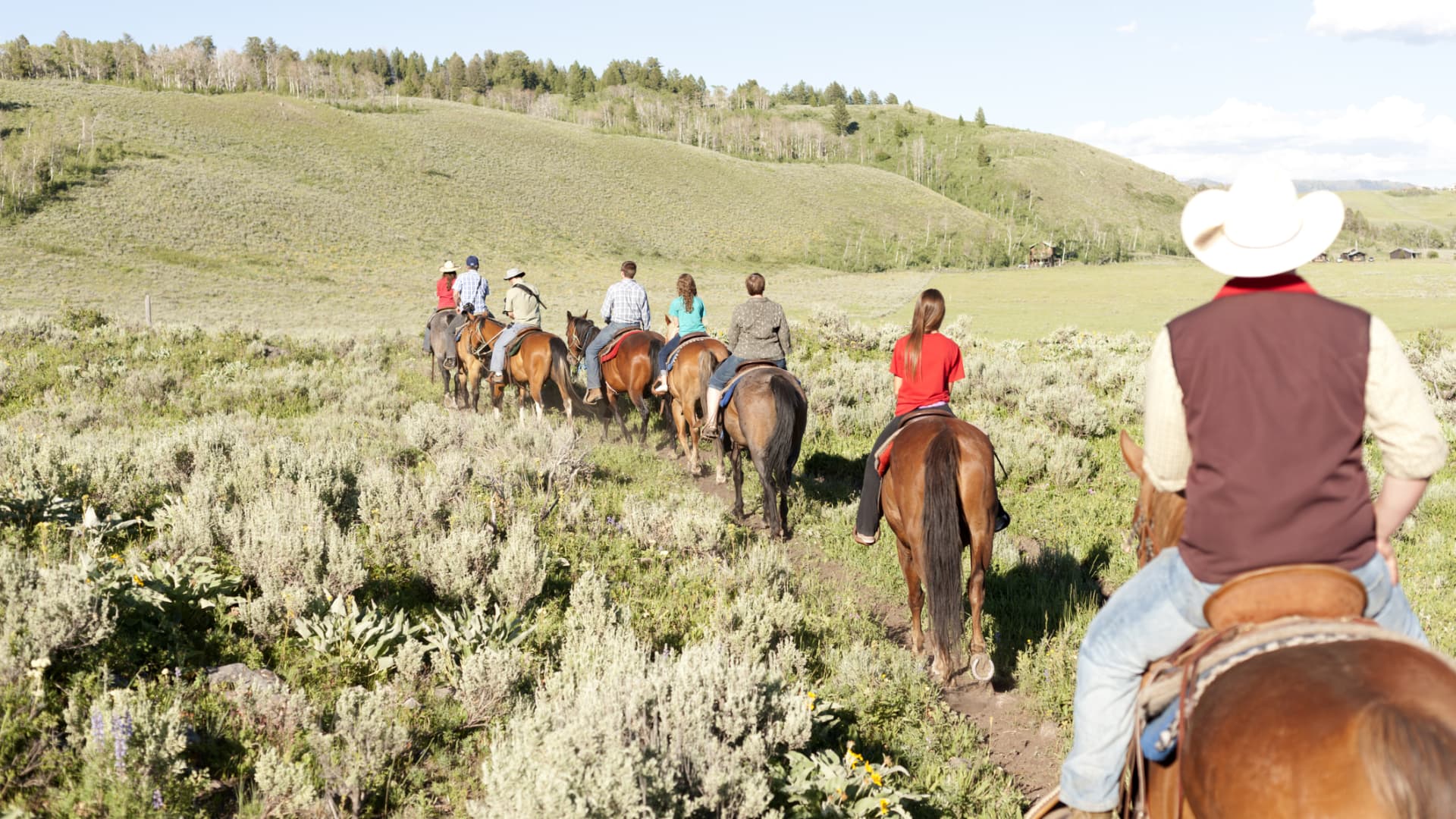 Horseback riders embarking on a trail in West Yellowstone, Montana.