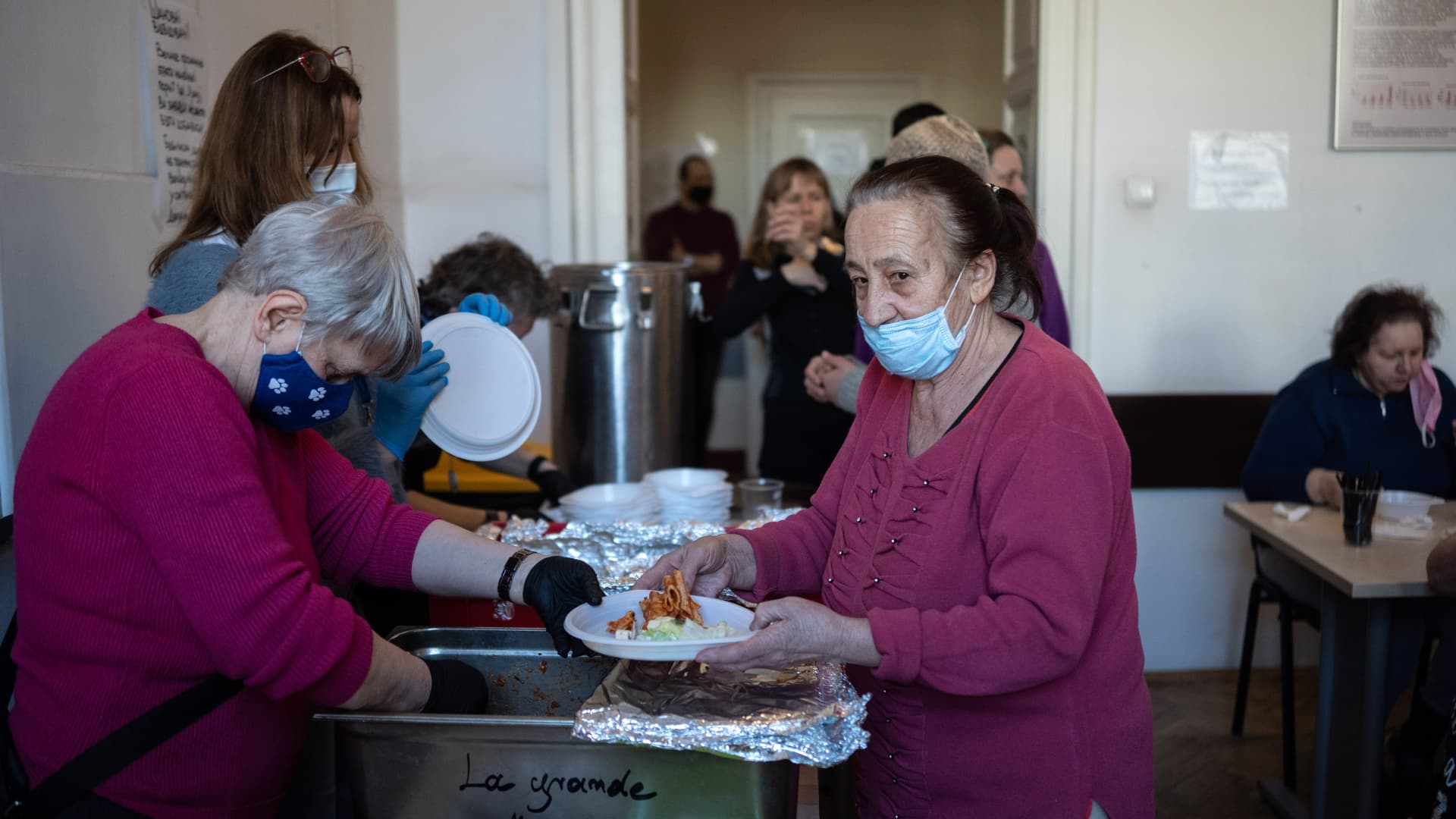 Lunch is served in a dining room of a former hospital building operating as a temporary shelter for displaced Ukrainians in Krakow, Poland, on Monday, March 14, 2022.