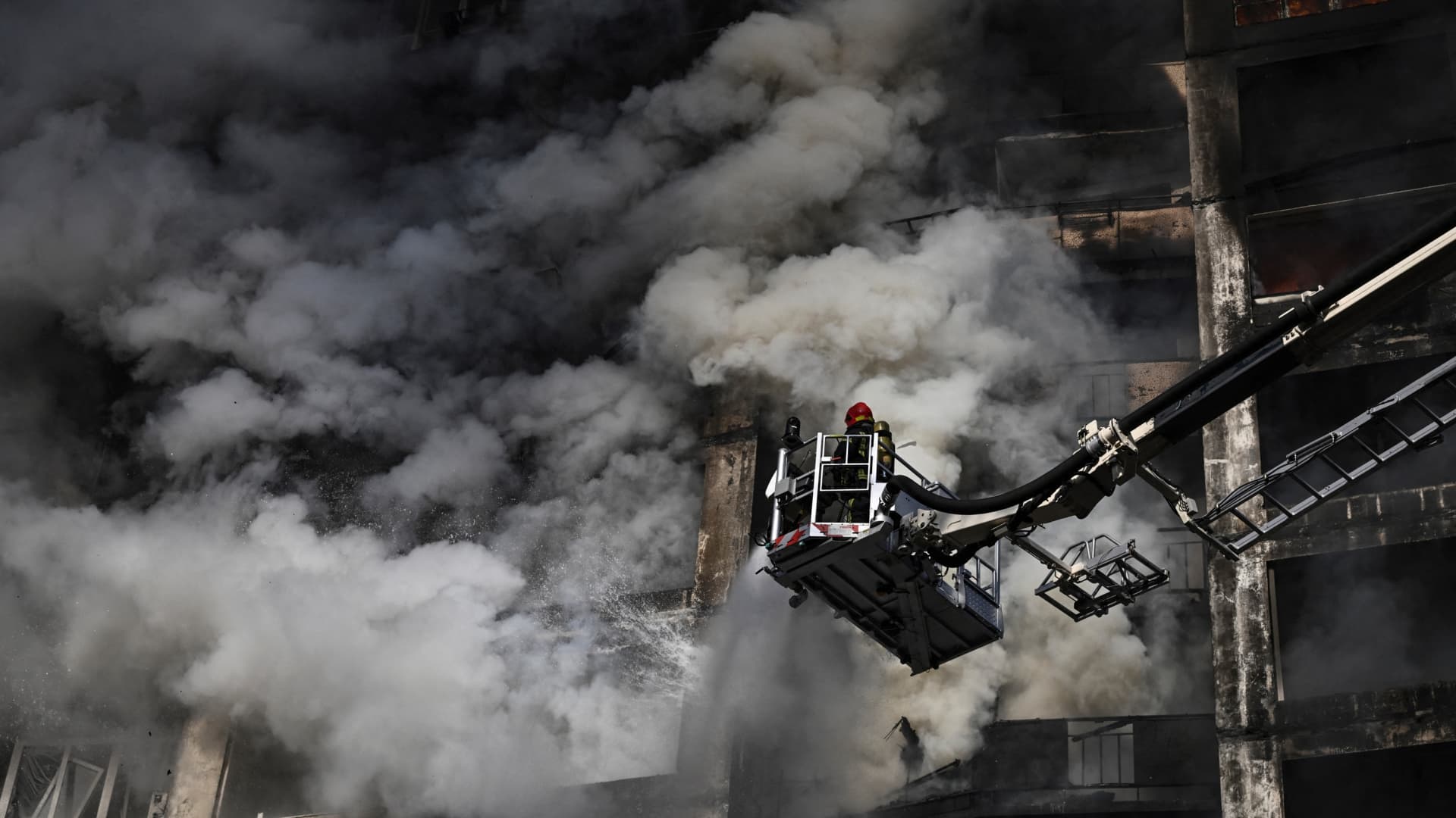 Firemen are at work to extinguish a fire that broke out in an apartment building hit by shelling in Kyiv on March 15, 2022, after strikes killed at least two people, Ukraine emergency services said as Russian troops intensified their attacks on the Ukrainian capital.
