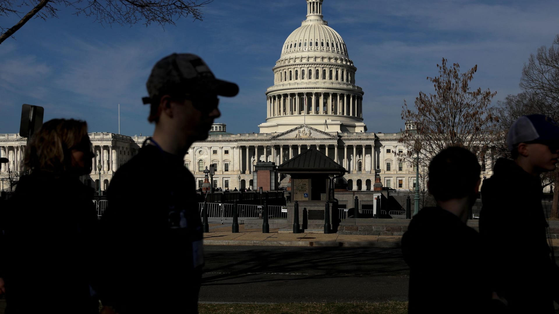 Pedestrians walk by the United States Capitol building in Washington, March 15, 2022.