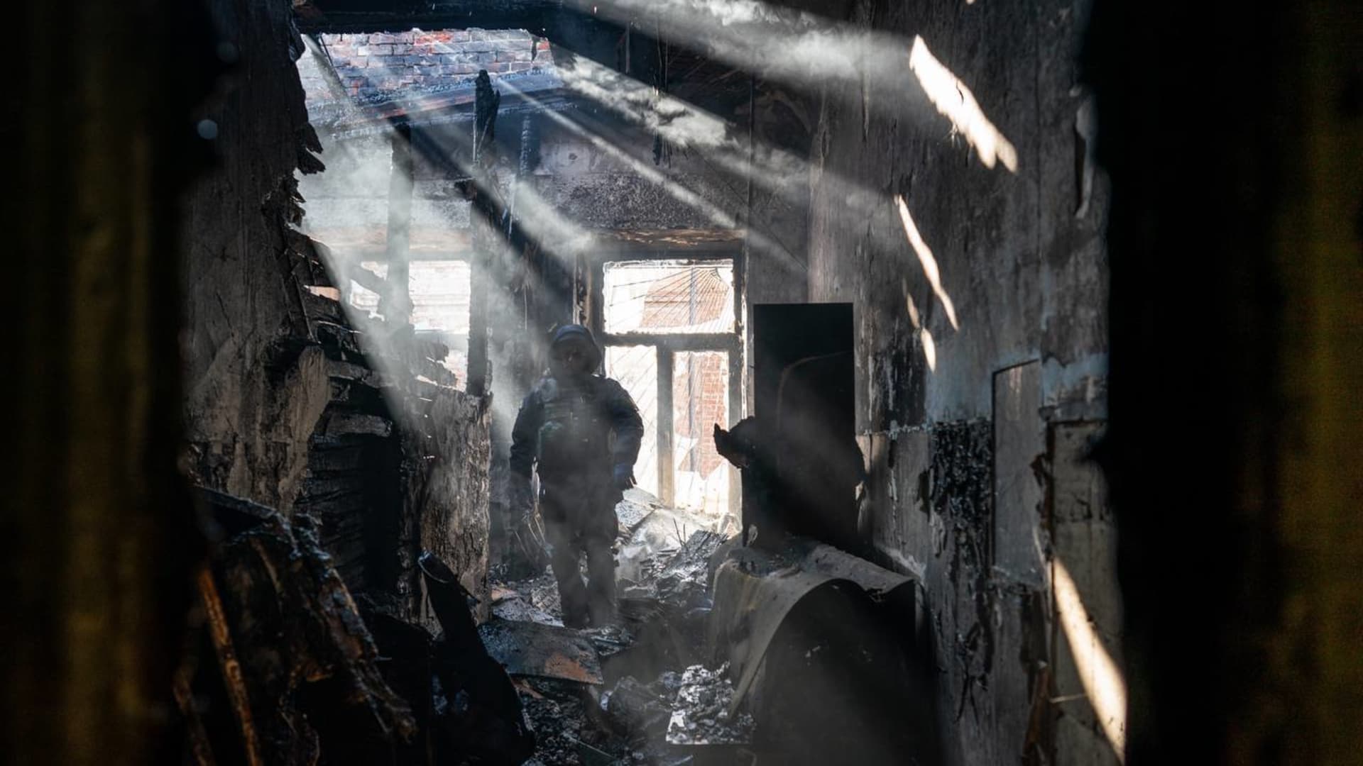 First responders work in a building that was struck by a Grad rocket attack in Kharkiv, Ukraine on March 15, 2022.
