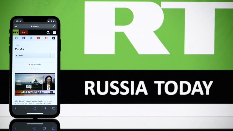 A picture taken on Oct. 5, 2021 in Toulouse shows the logo of RT (Russia Today) TV channel displayed by a tablet.