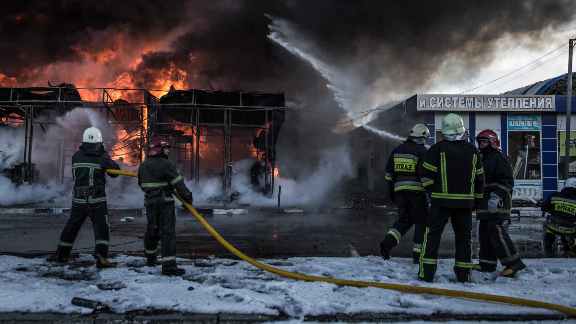 Firefighters try to extinguish a fire broke out at the Saltivka construction market, hit by 6 rounds of Russian heavy artillery in Kharkiv, Ukraine on March 16, 2022.