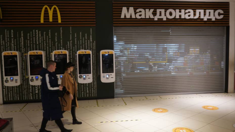 Men walk past a closed McDonald's restaurant inside a shopping mall on March 15, 2022, in Moscow, Russia. McDonald's closed all its restaurants, KFC suspended any investment in Russia as a result of the U.S. and EU economic sanctions.
