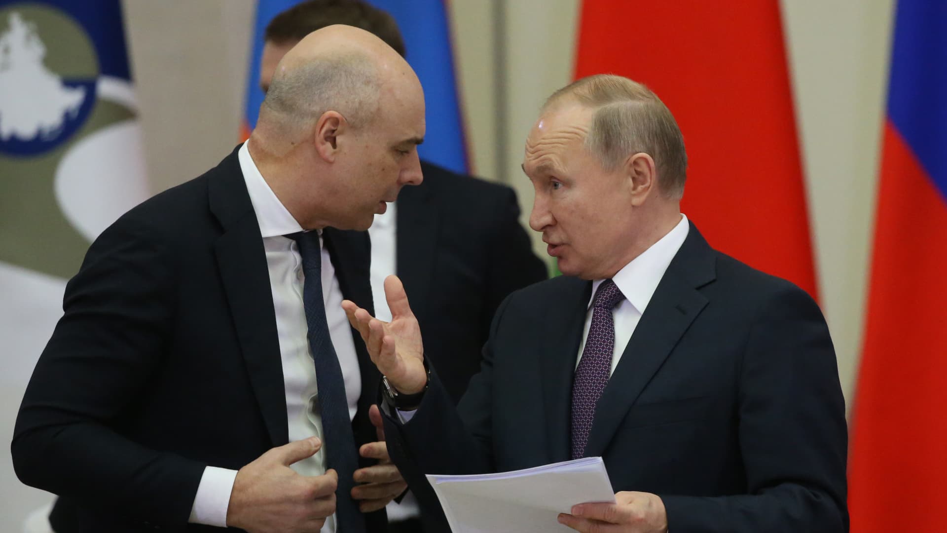 Russian Finance Minister Anton Siluanov (seen here with Russian President Vladimir Putin in 2019) reportedly told Russian newspaper Vedomosti that Moscow will continue to service external debts in rubles, but foreign Eurobond holders will need to open ruble and hard currency accounts with Russian banks in order to receive payments.