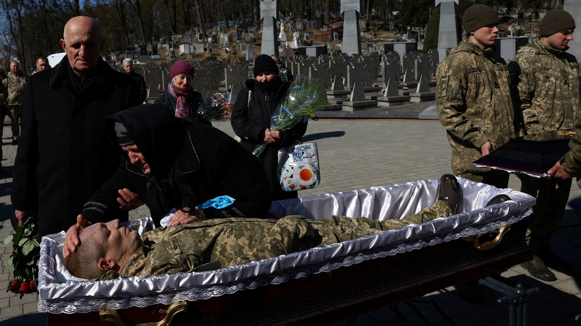SENSITIVE MATERIAL. THIS IMAGE MAY OFFEND OR DISTURB Family members and comrades of Ivan Skrypnyk, who was killed in a rocket attack against a military base in Yavoriv during the ongoing Russian invasion, pays their last respect during his memorial service in Lviv, Ukraine, March 17, 2022.