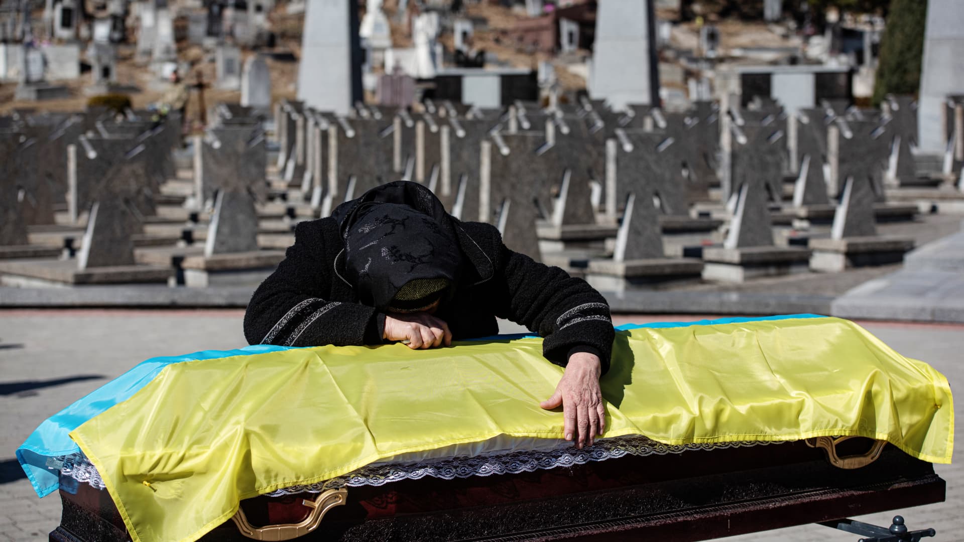 The mother of Ukrainian officer Ivan Skrypnyk cries over the coffin with the body of her son, during the funeral ceremony on March 17, 2022 in Lviv, Ukraine.