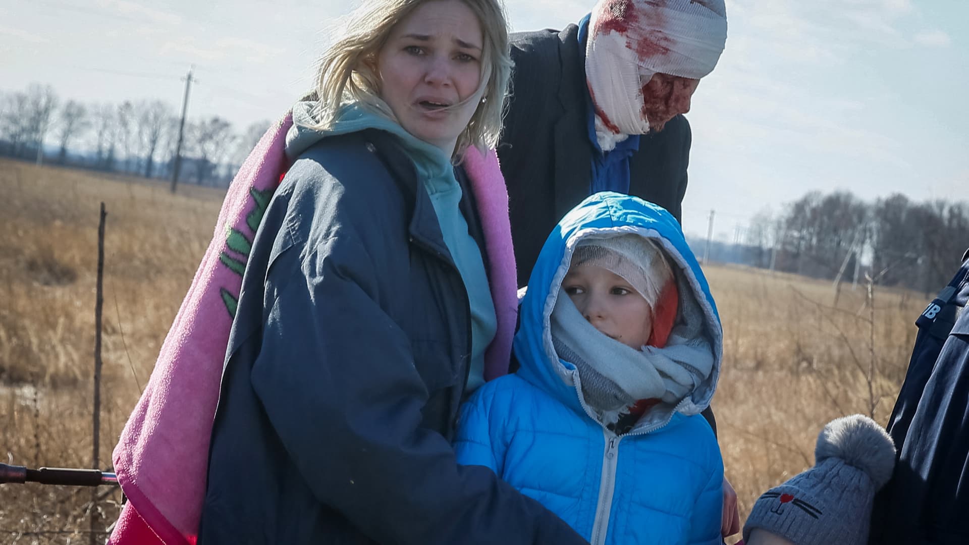 People react as they evacuate from a village occupied by Russian troops on the front line, in the north Kyiv region, Ukraine March 17, 2022.